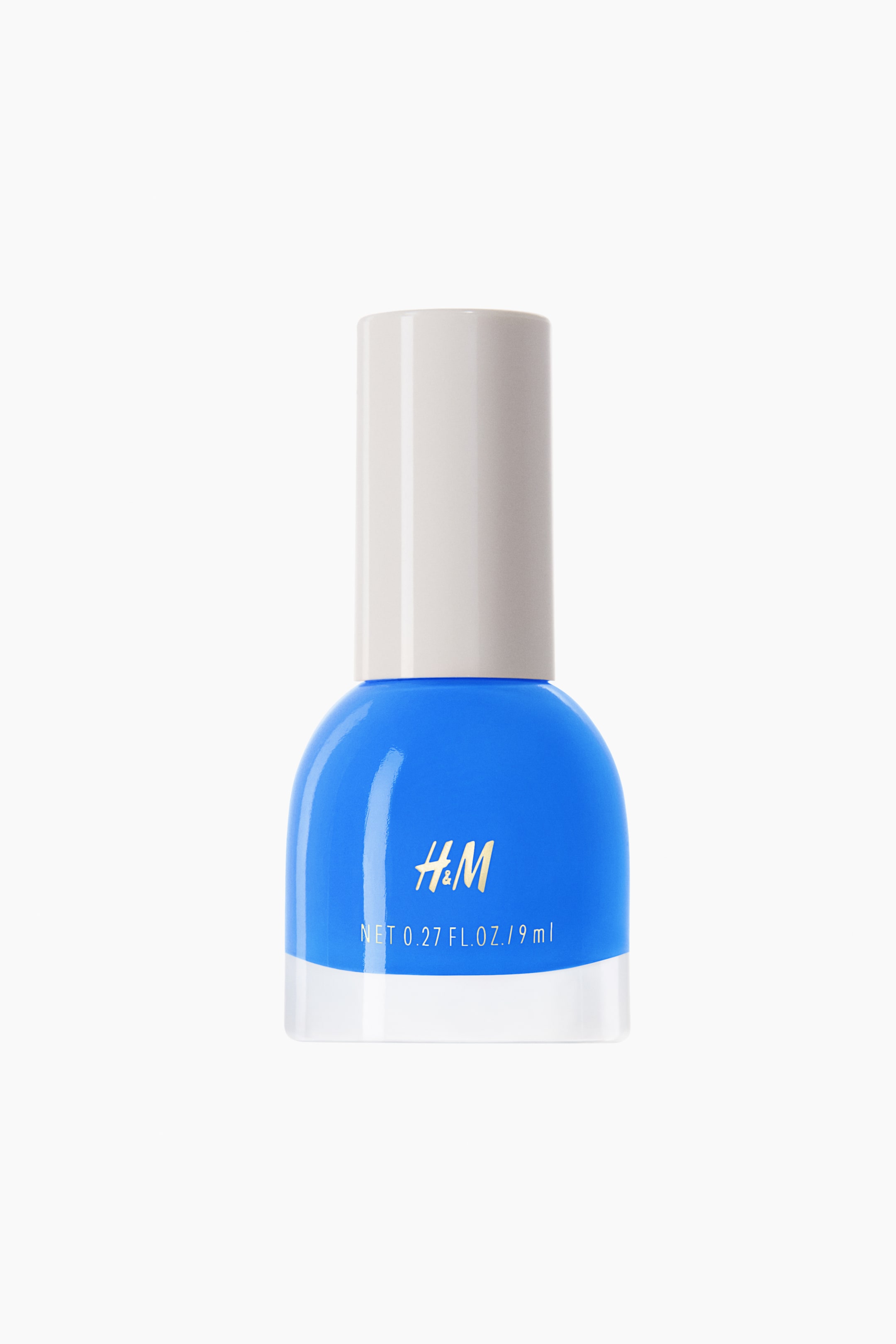 View larger image: Nail polish. A compact, rounded bottle contains vibrant blue polish and is capped with a light grey cylindrical lid. The front of the bottle showcases a gold "H&M" logo accompanied by white volume text.