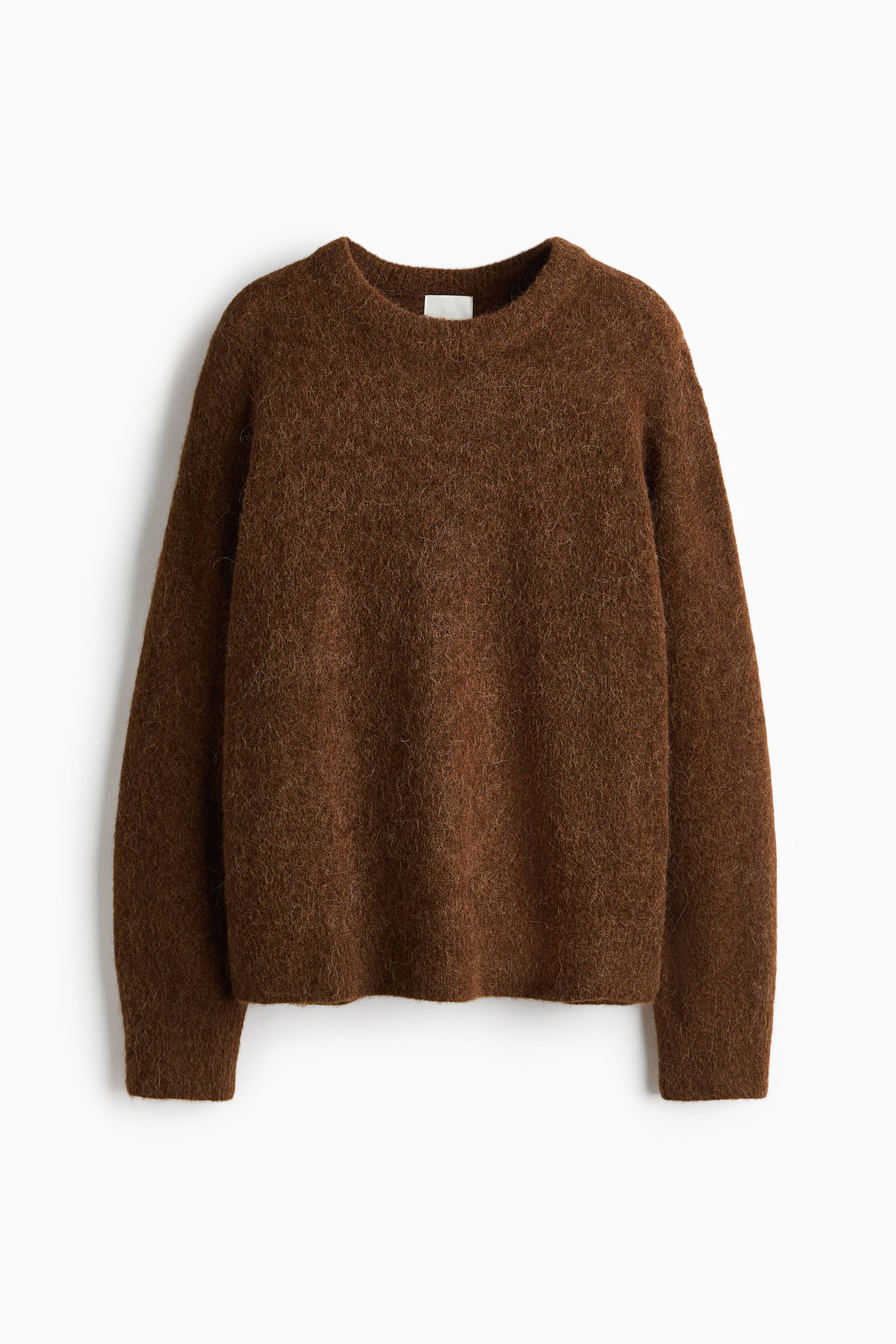 View larger image: A brown fuzzy knit sweater is shown from the front, featuring a crew neck and long sleeves. It is displaying a relaxed fit with finished cuffs and hem, and a small white label is visible at the back of the neck.