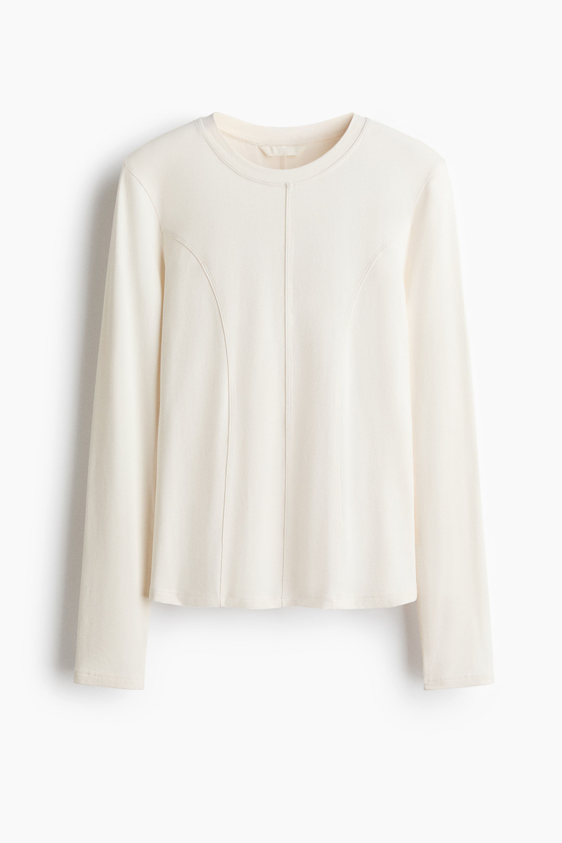 View larger image: An off-white long-sleeve top is hanging flat and facing directly forward, featuring a crew neck and prominent curved and vertical seam detailing on its front panel.