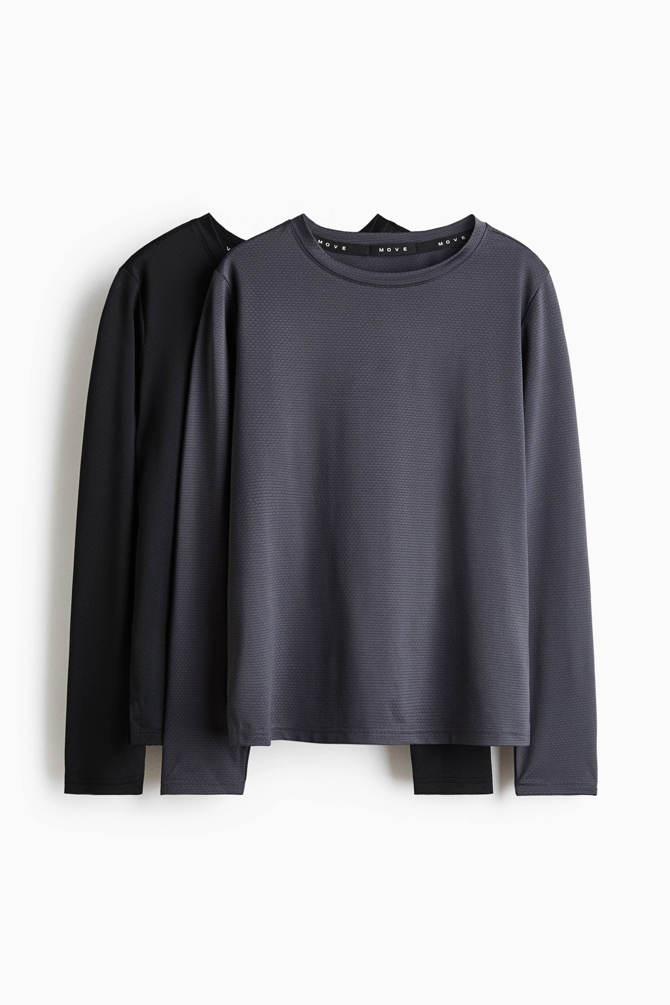 View larger image: A two-pack of long-sleeved sports tops is presented, featuring a dark grey top with a subtle textured fabric, a crew neck with a 'MOVE' branded neckband, and long sleeves. A black long-sleeved top is layered behind it, also featuring a similar textured fabric.