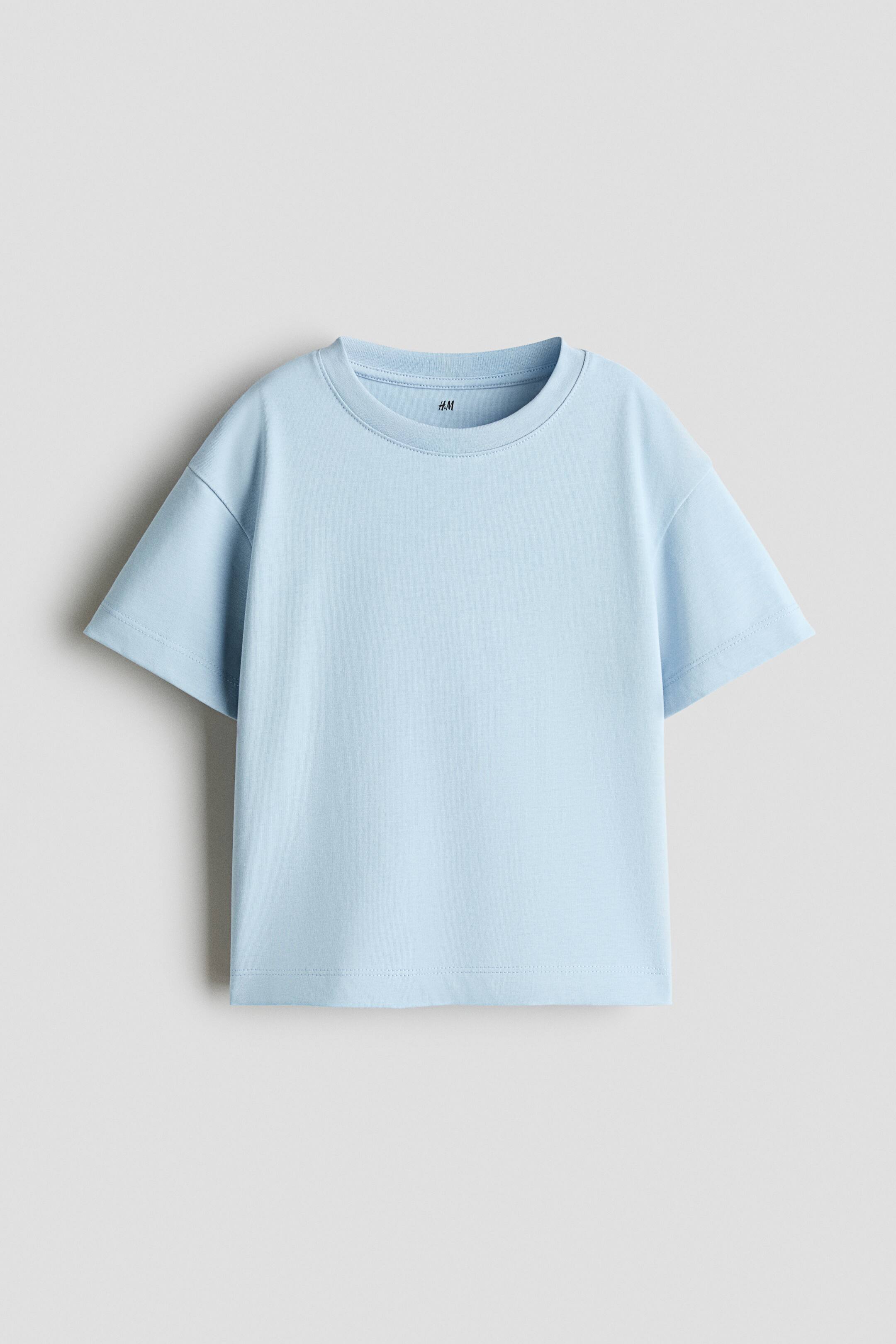 View larger image: A light blue t-shirt is shown from the front, featuring a crew neck with a ribbed collar, dropped shoulders, and short sleeves. The t-shirt has a relaxed fit with a straight hem.