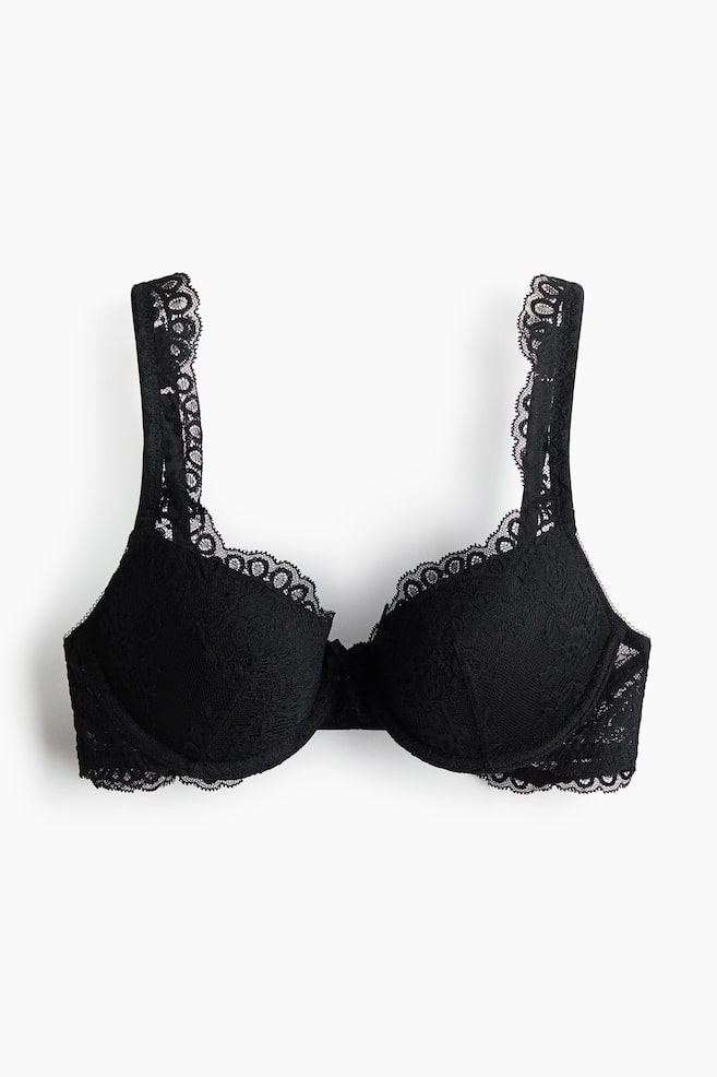 A black lace push-up bra is presenting from the front, featuring padded, underwired cups, adjustable shoulder straps with scalloped lace trim, and a small bow at the center gore. - 1