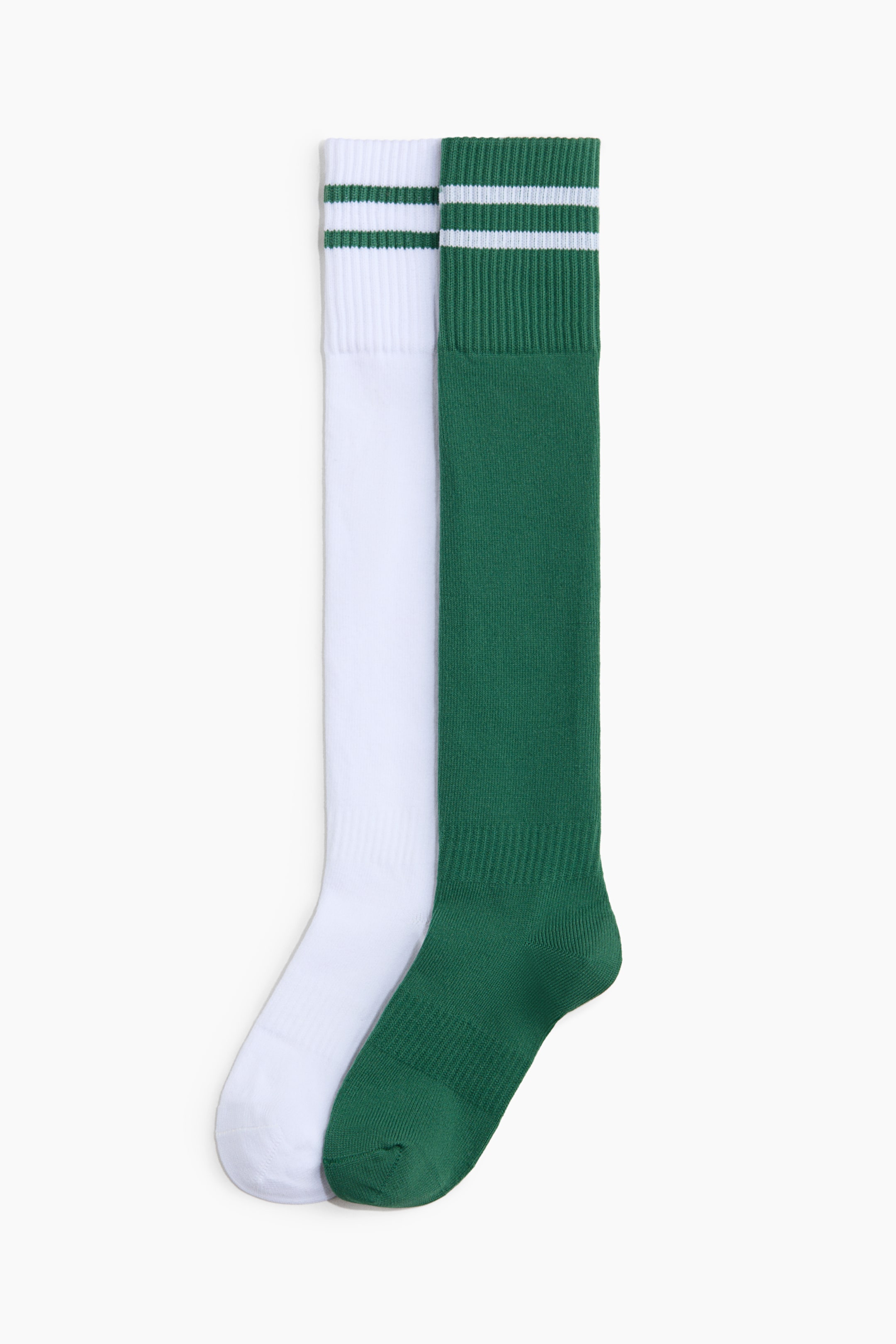 View larger image: The 2-pack football socks with DryMove? feature a white sock adorned with two green stripes on its ribbed cuff, alongside a green sock highlighted by two white stripes on its ribbed cuff. Both knee-high socks showcase distinct heel and toe areas, positioned side-by-side and facing forward.