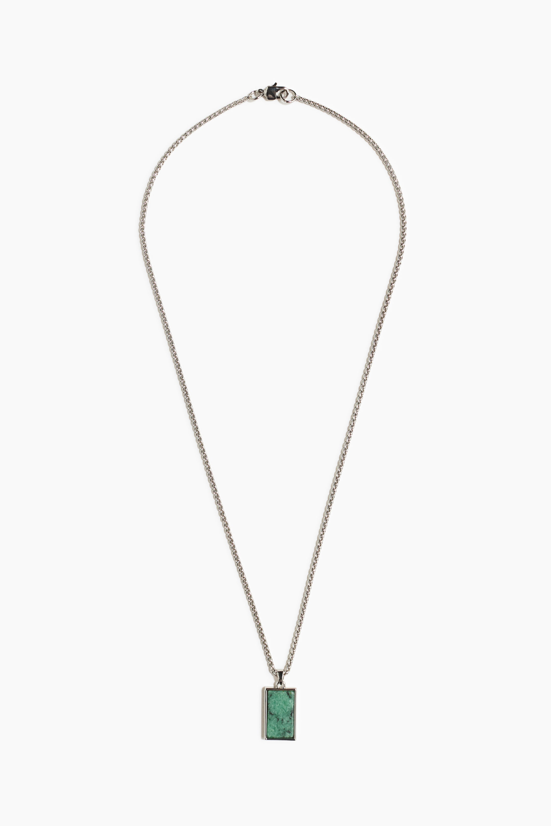 View larger image: The necklace features a finely woven silver-toned chain, which suspends a rectangular green stone pendant enclosing a textured green stone within a silver-toned bezel.