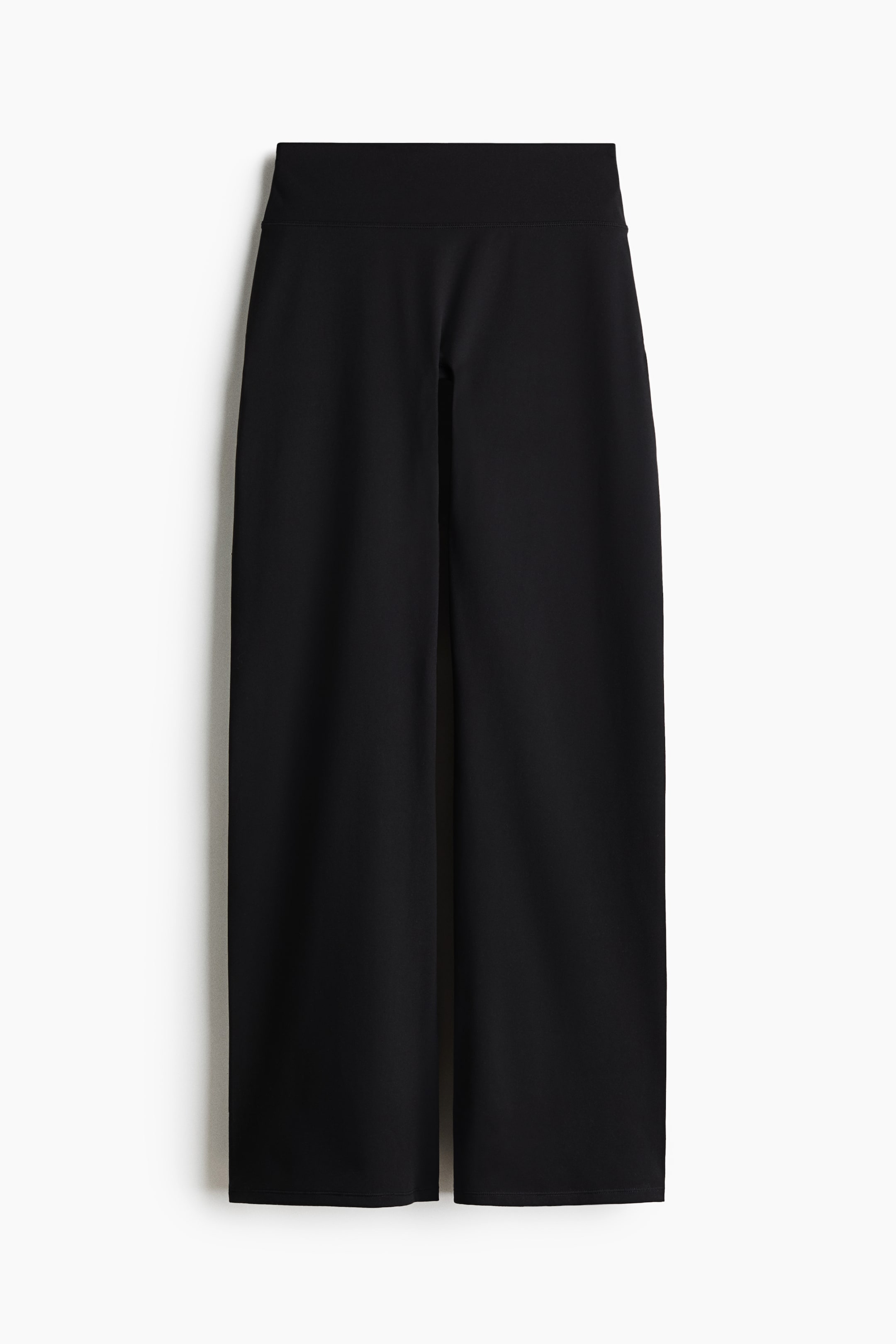 View larger image: Black cropped pants are shown in a front view, highlighting a wide, flat waistband and wide, straight legs that are cropped above the ankles.