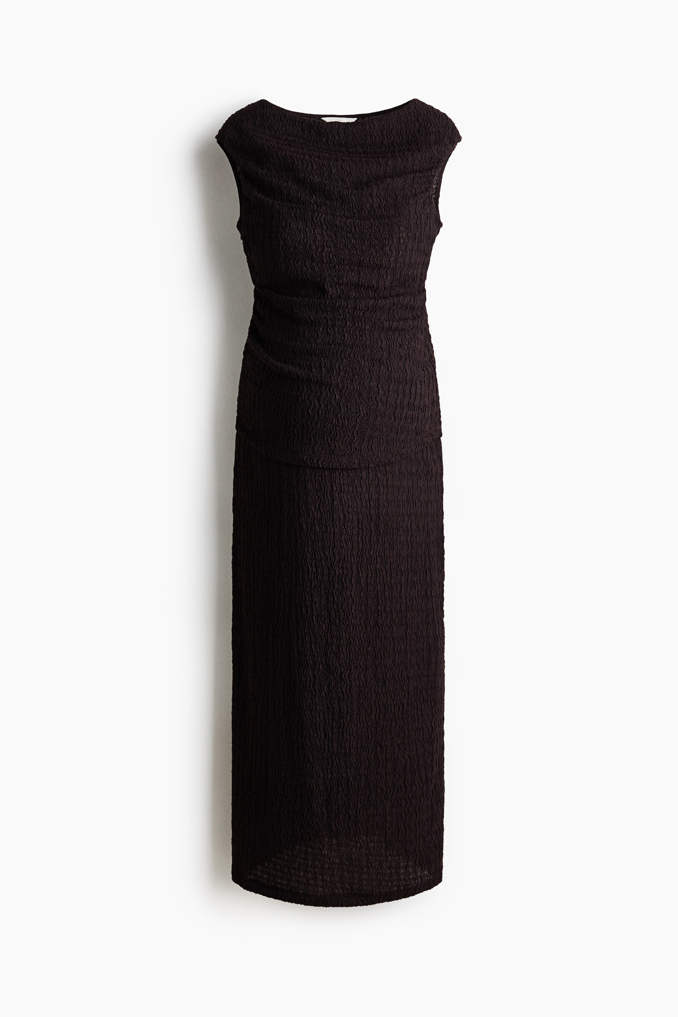 View larger image: A dark brown maxi dress showcases a textured, shirred fabric throughout, from the wide boat neckline and short cap sleeves to the floor-length column skirt.