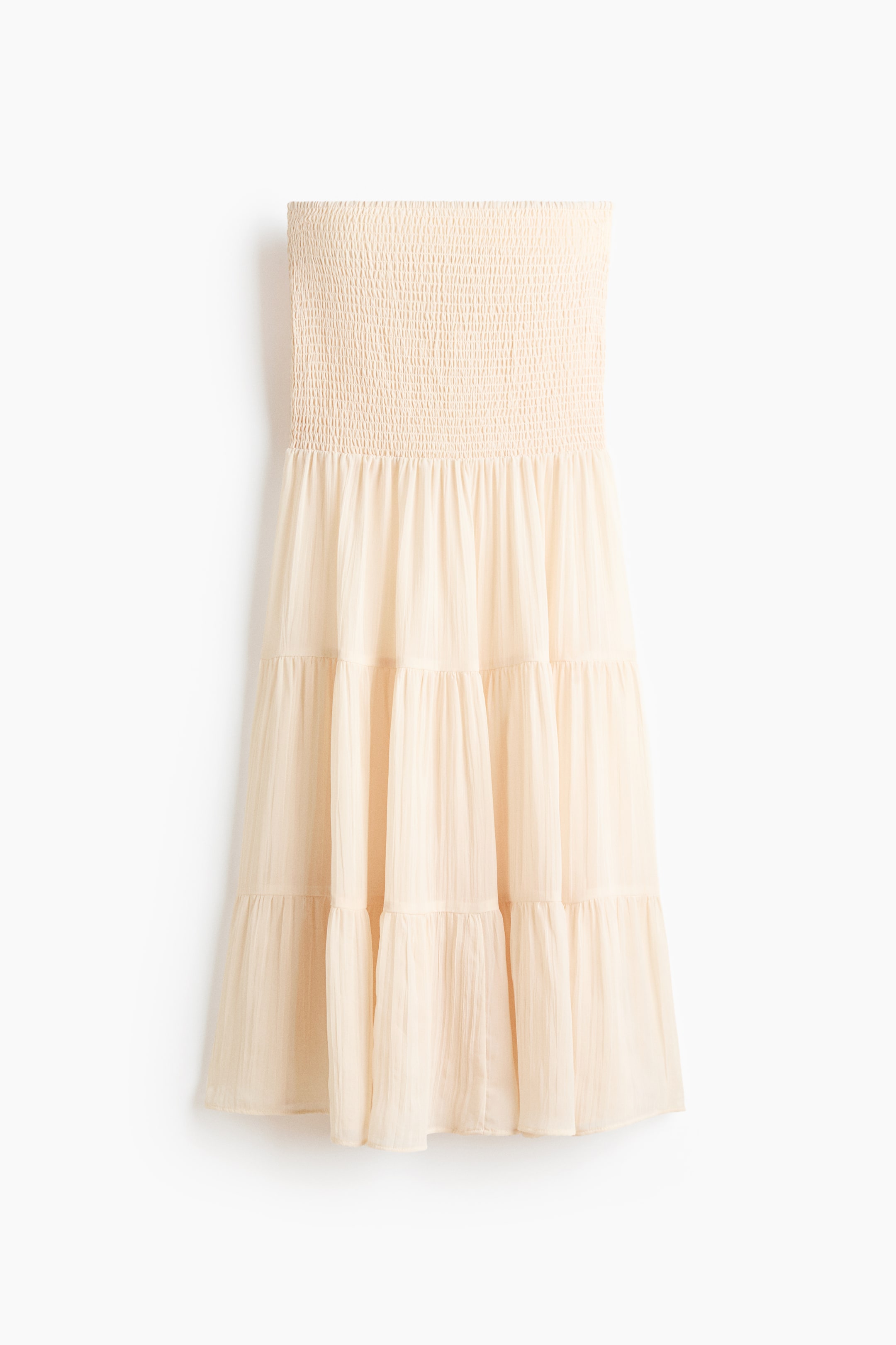 הצגת תמונה גדולה יותר: שמלת קרם בהירה עם מחוך סטרפלס מעוצב בגומיות. החצאית מורכבת משלוש שכבות של בד זורם, והחומר מציג מרקם מקומט בעדינות במבט קדמי.
