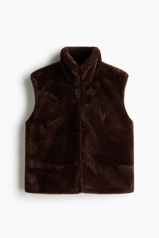 A brown faux fur gilet features a plush texture, a high stand-up collar, and a vertical seam running down the centre front. - 1