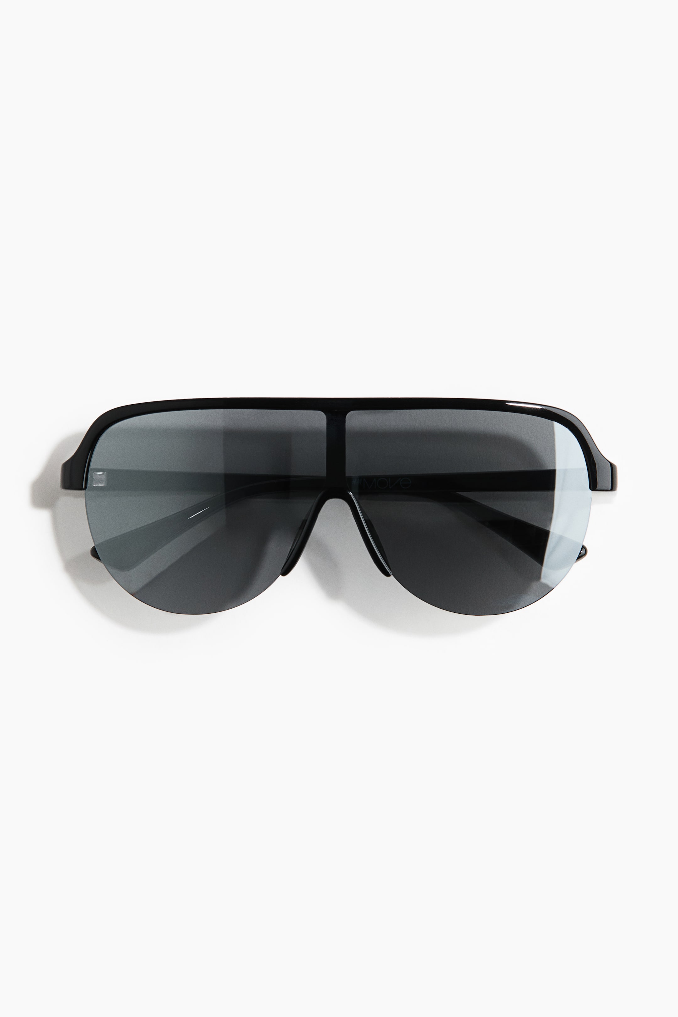 View larger image: The sunglasses are shown from the front, featuring black polycarbonate frames and temples. A large, dark plastic shield lens offers extensive coverage and is designed with a rimless bottom edge.