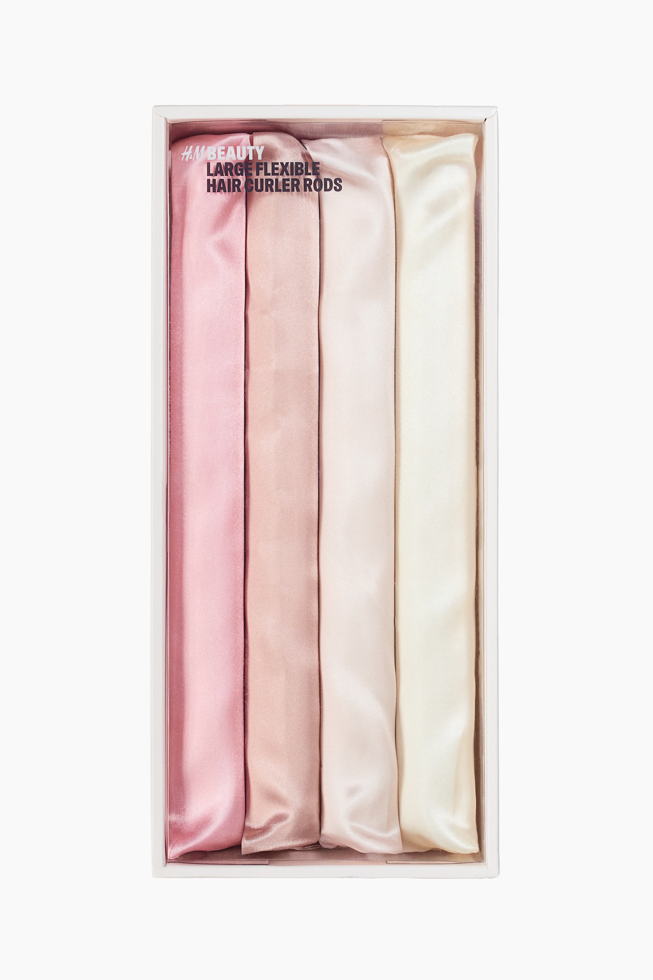 View larger image: Displayed in a sleek white rectangular box is a set of four flexible hair curler rods. Each rod is wrapped in soft satin fabric, showcasing a gradient of light pink, rose pink, light beige, and cream tones, arranged side by side.