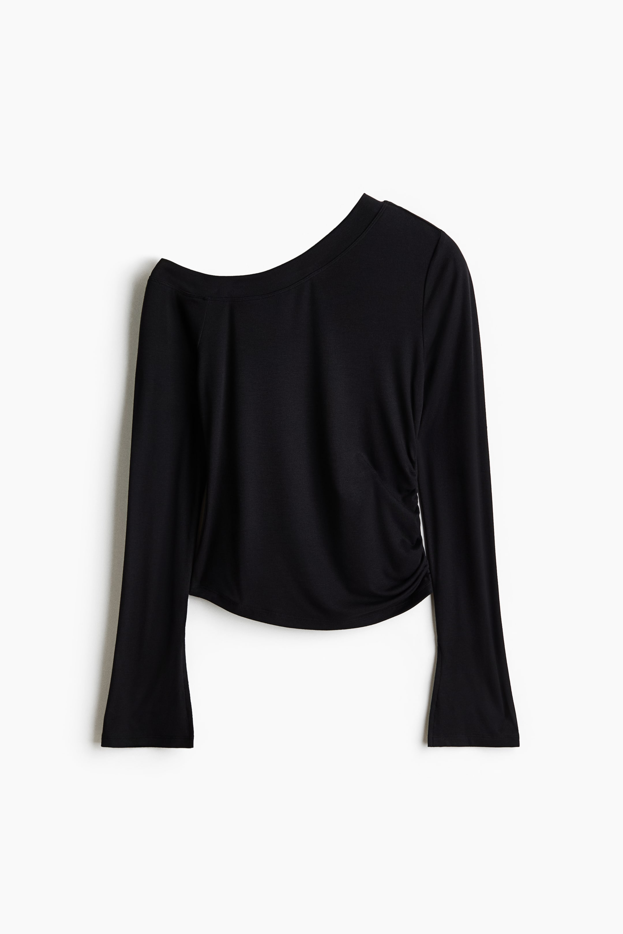 View larger image: A black long-sleeved top is laid flat, facing forward, featuring an asymmetrical neckline with one side styled as off-shoulder and the other as a round neck, while gathered ruching is visible on the right side of the body.