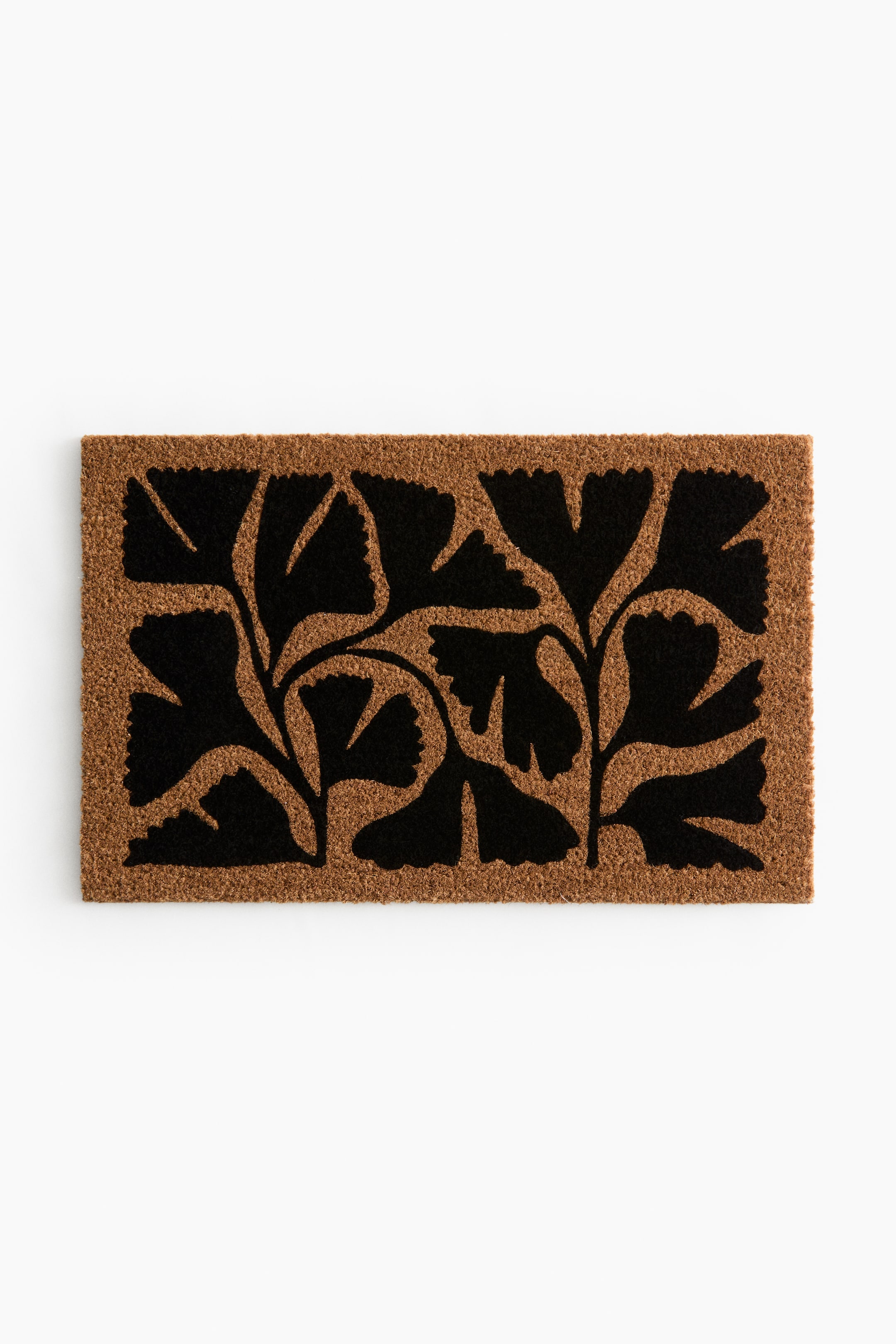 View larger image: A rectangular doormat is presenting a black ginkgo leaf pattern over a brown coir surface.