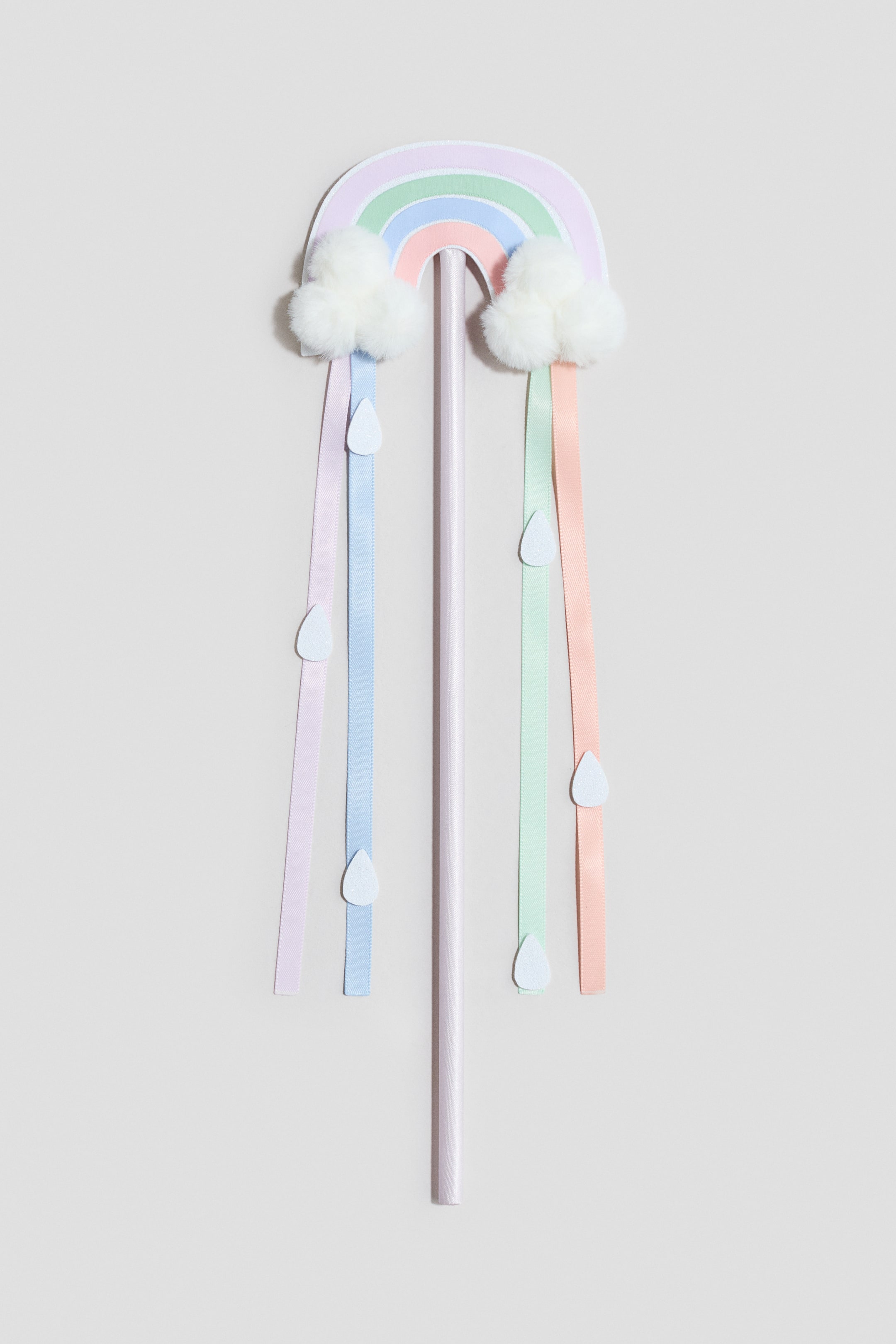 View larger image: A decorative wand is displayed from the FRONT, featuring a pastel rainbow arch with fluffy white clouds on each end. Four coordinating pastel ribbons with white teardrop-shaped embellishments are hanging from the clouds, and a light purple stick is extending downward as the handle.
