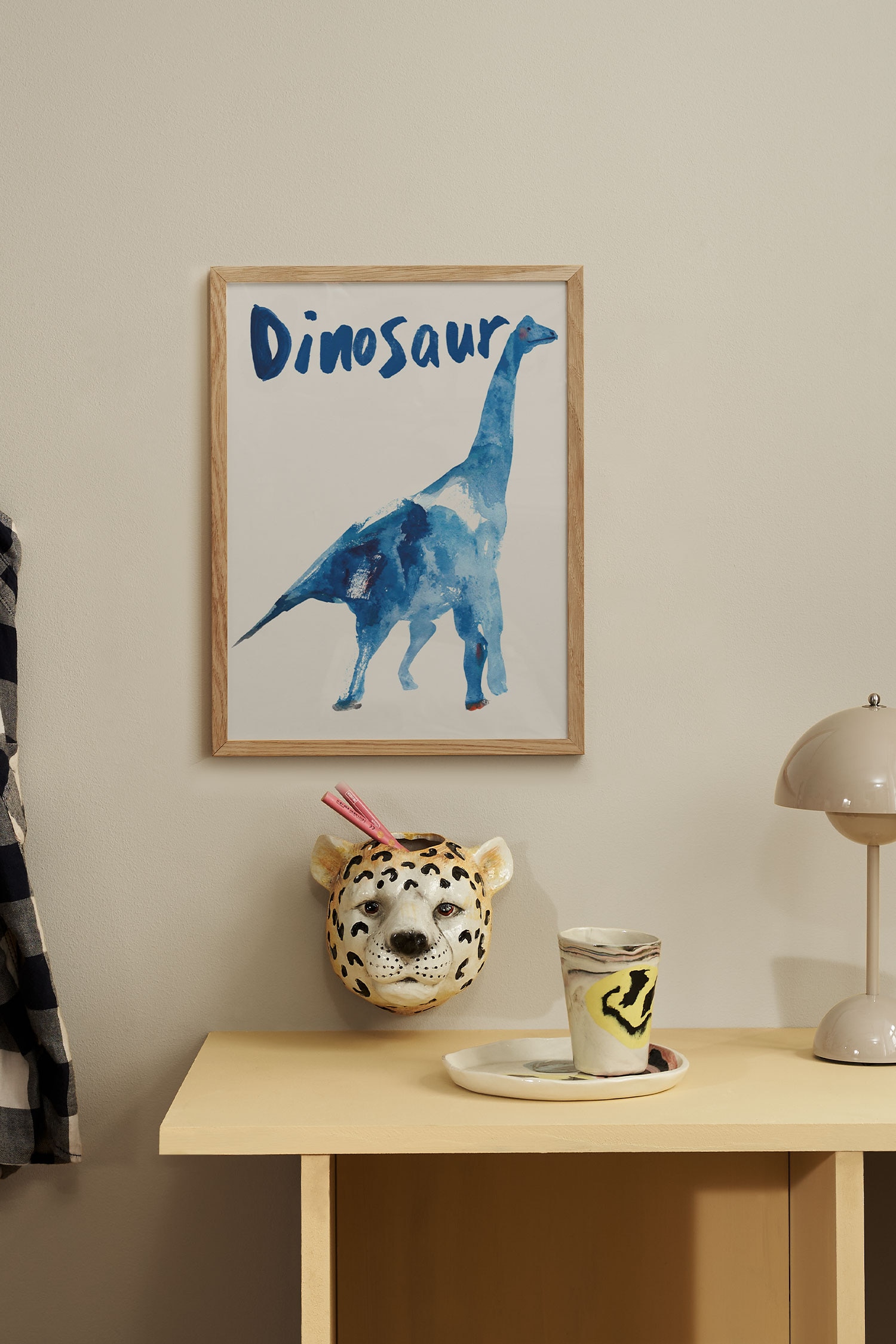 Een kunstprint toont een aquarelillustratie van een dinosaurus met een lange nek, naar rechts gericht, weergegeven in blauwtinten op een gebroken witte achtergrond. Het woord "Dinosaur" verschijnt bovenaan de print in gestileerde blauwe penseelstreken.