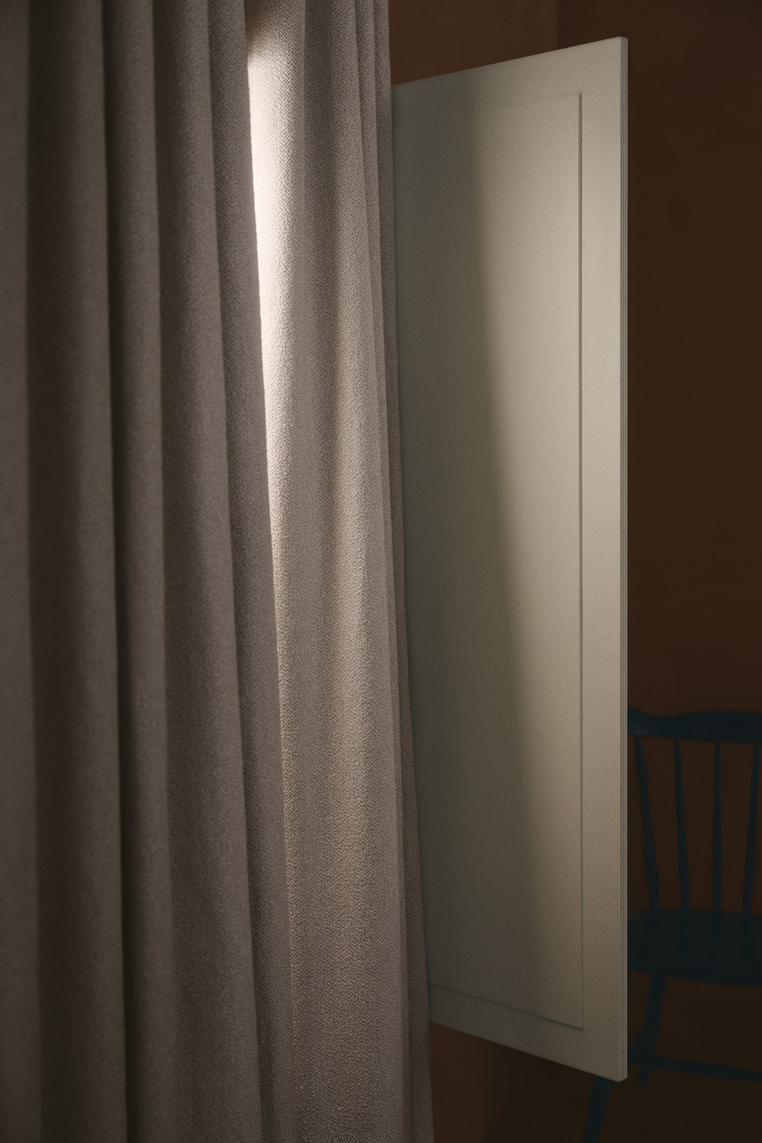 A light beige curtain is hanging in deep, consistent vertical pleats, featuring a subtle, heathered woven texture. - 1
