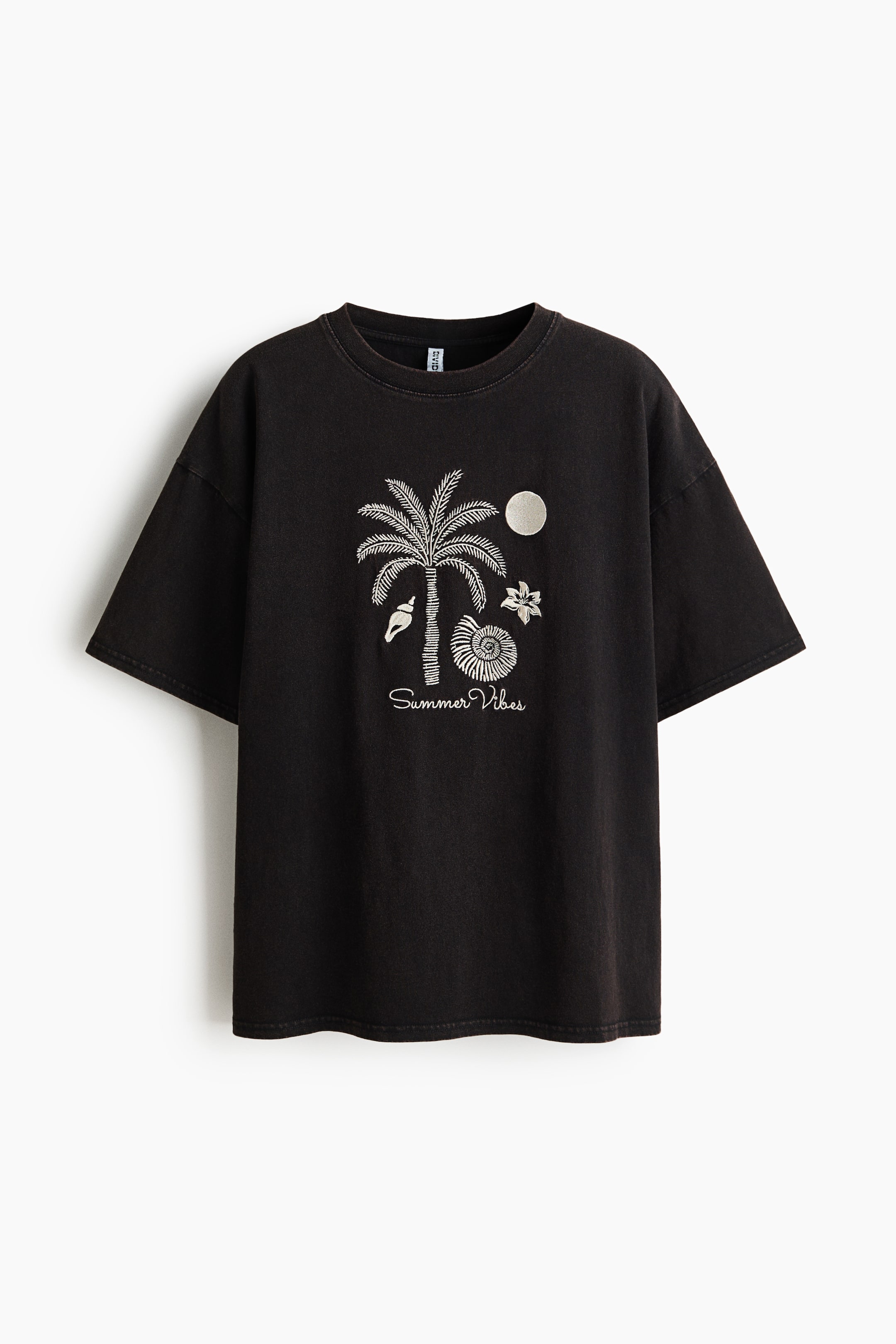 View larger image: A black, slightly faded oversized t-shirt is showcasing its front, featuring a crew neck and short sleeves with dropped shoulders. A detailed white graphic on the chest depicts a palm tree, two shells, a flower, a circular shape, and the script text 'Summer Vibes'.