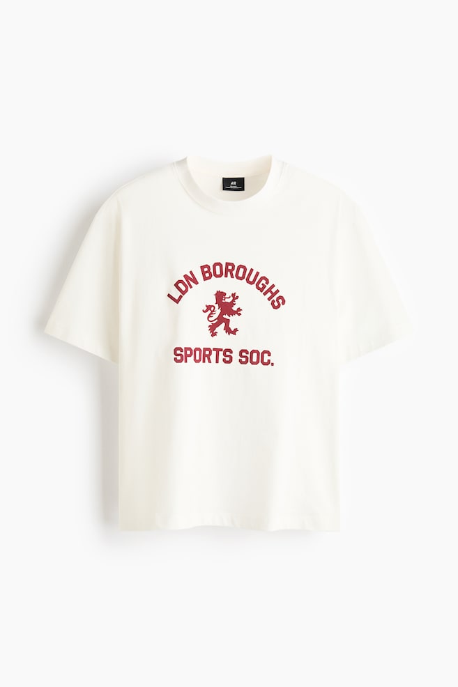 A cream-coloured t-shirt in soft jersey is facing front, featuring a round, rib-trimmed neckline and dropped shoulders. A dark red graphic print, displaying 'LDN BOROUGHS' arched over a lion crest and 'SPORTS SOC.' below, is appearing on its chest, while the t-shirt is showcasing a straight-cut hem and a relaxed fit. - 1