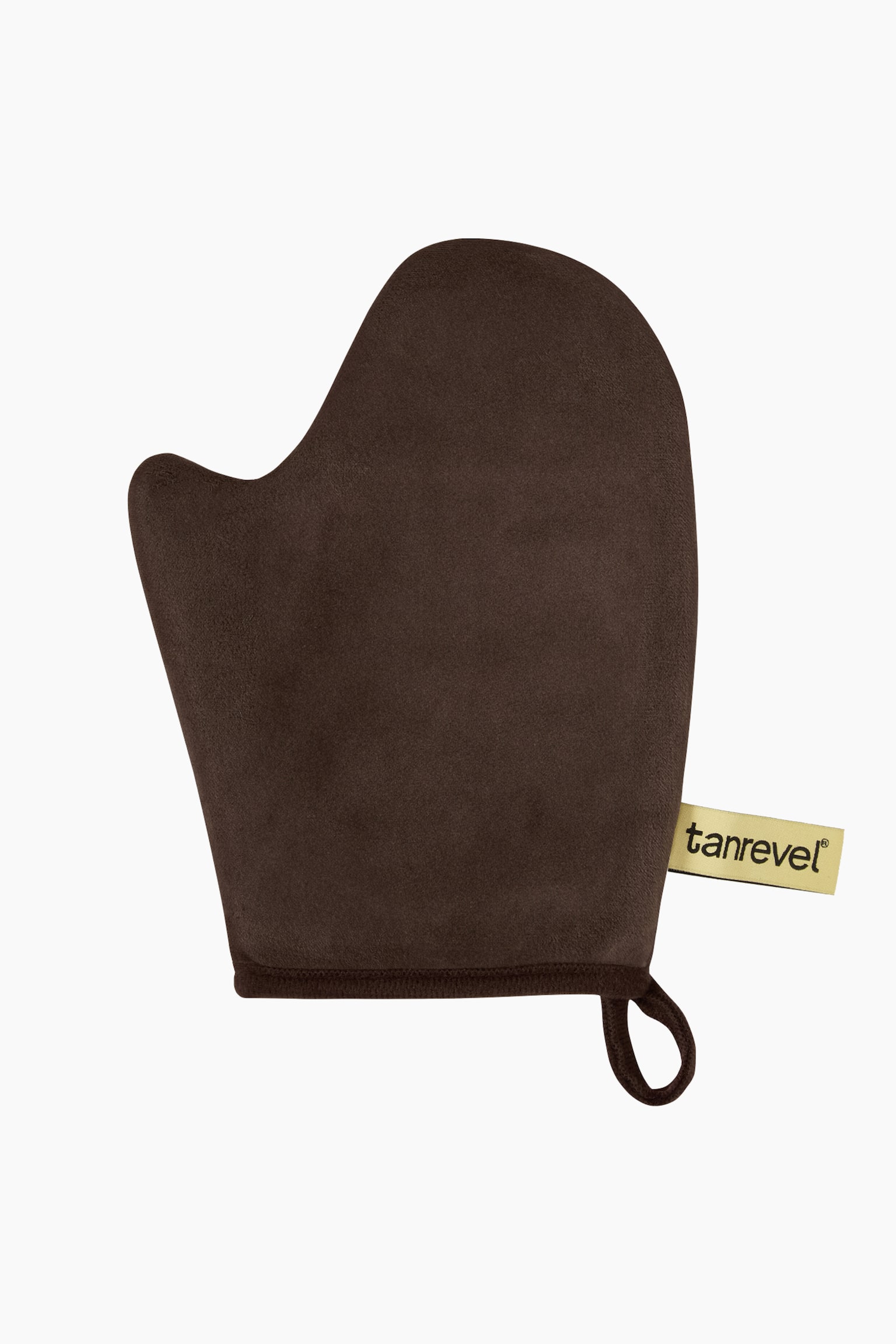 En mÃ¶rkbrun self-tan-handske visar en mjuk, sammetliknande struktur med ett separat tumfack. Den Ã¤r vÃ¤nd framÃ¥t och framhÃ¤ver en kantad Ã¶ppning vid handleden med en fastsatt upphÃ¤ngningsÃ¶gla och en beige varumÃ¤rkesetikett pÃ¥ sidan. - 1