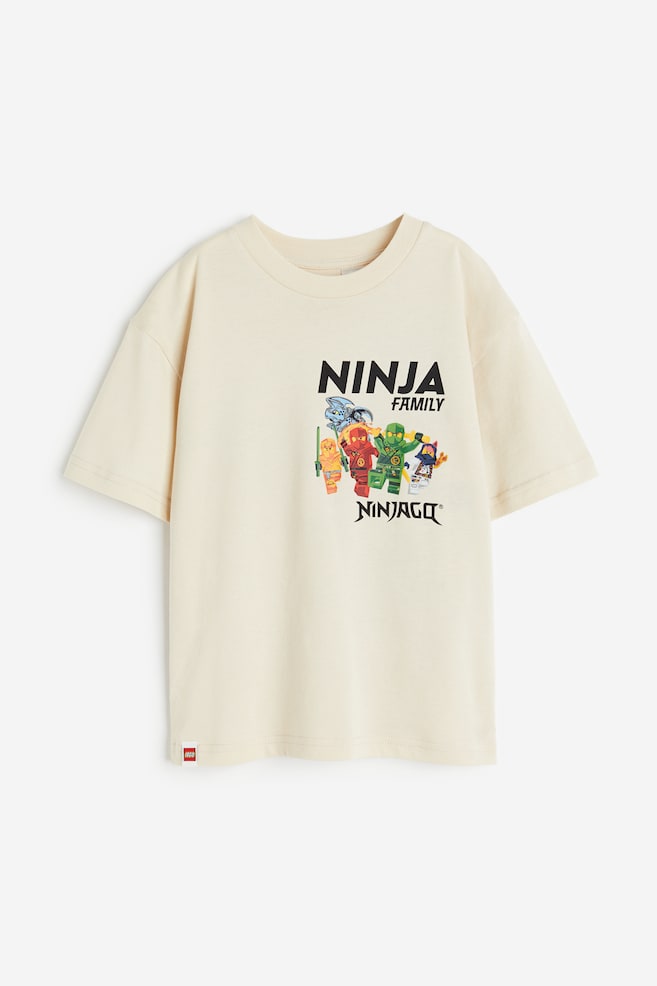 Printed T-shirt - Light beige/LEGO Ninjago/Black/Naruto/Cream/Jurassic World/Light green/Paw Patrol/dc/dc/dc - 1