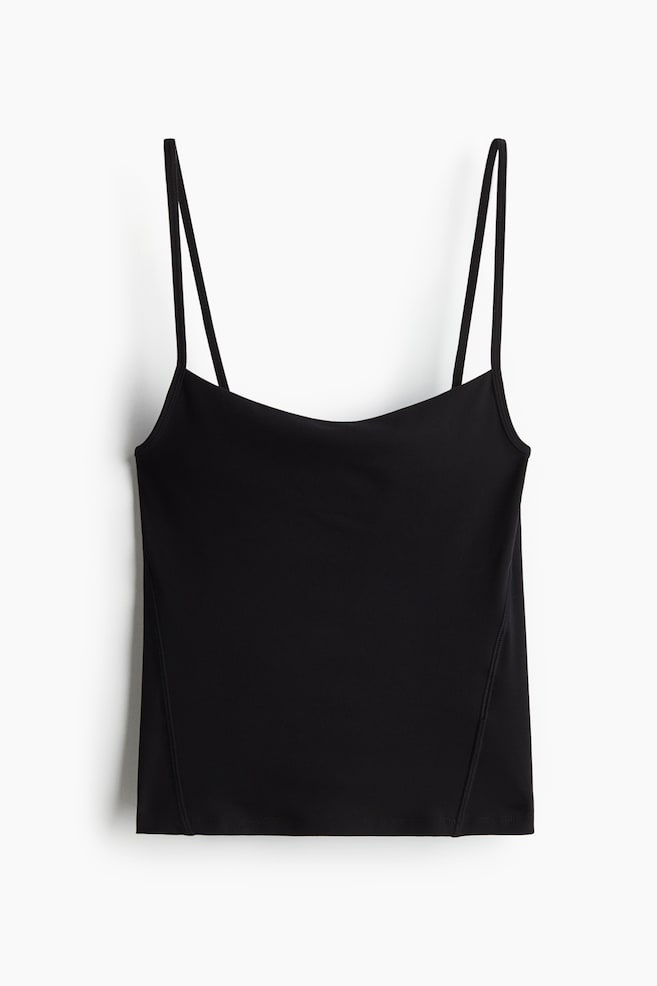 A black camisole is featuring thin spaghetti straps and a straight neckline, with its front showing a fitted silhouette and vertical side seams. - 1