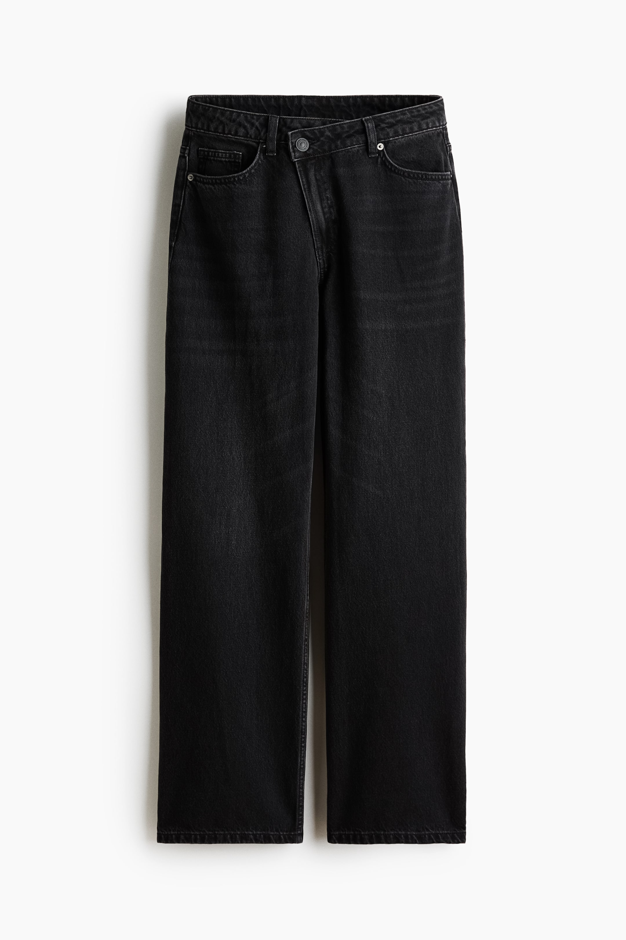 View larger image: Black denim jeans showcase a straight-leg fit with a washed black finish, featuring an asymmetrical crossover button waistband and front pockets adorned with silver-toned rivets.