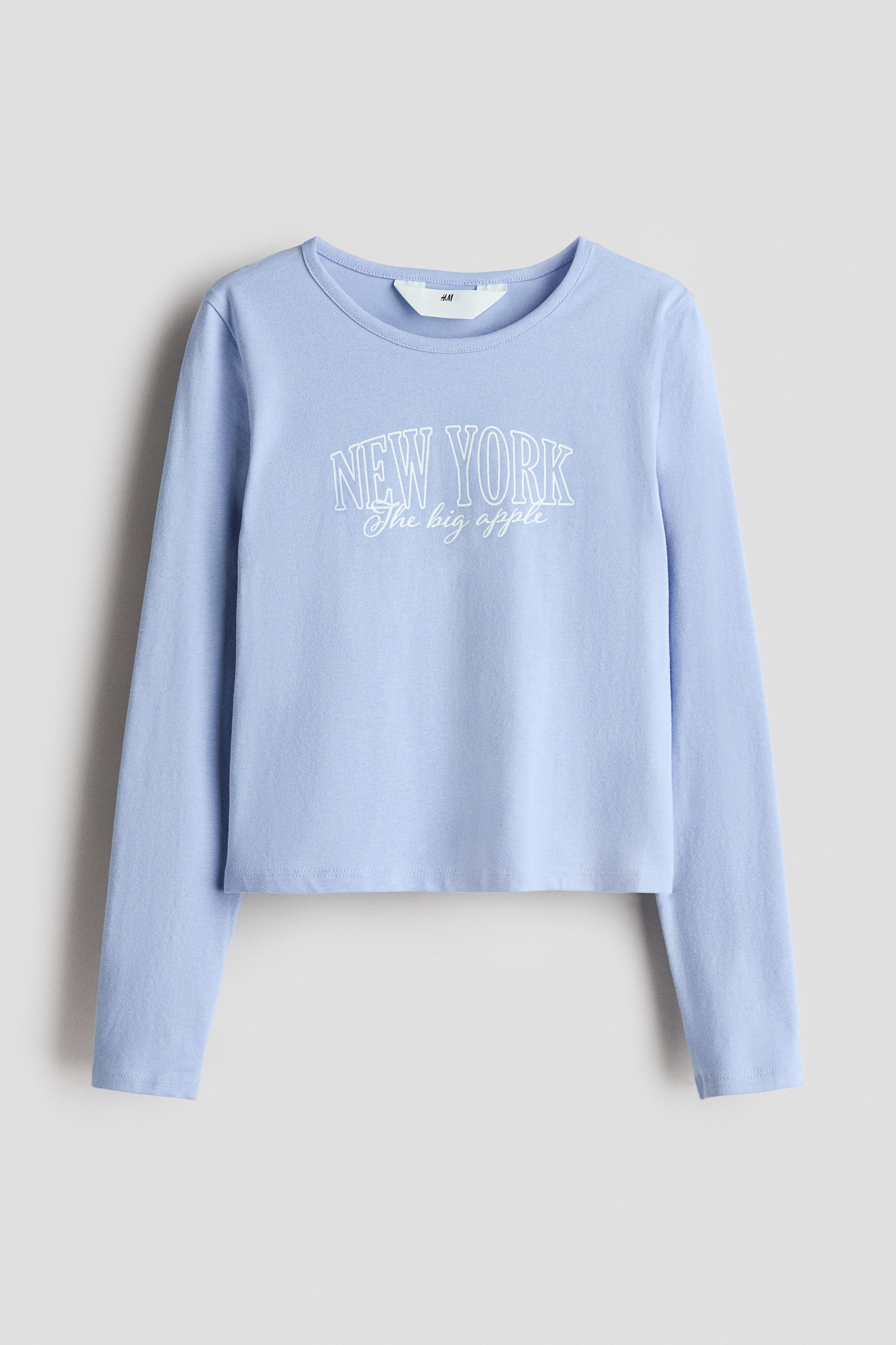 View larger image: On the chest, it is displaying a white 'NEW YORK The big apple' graphic print.