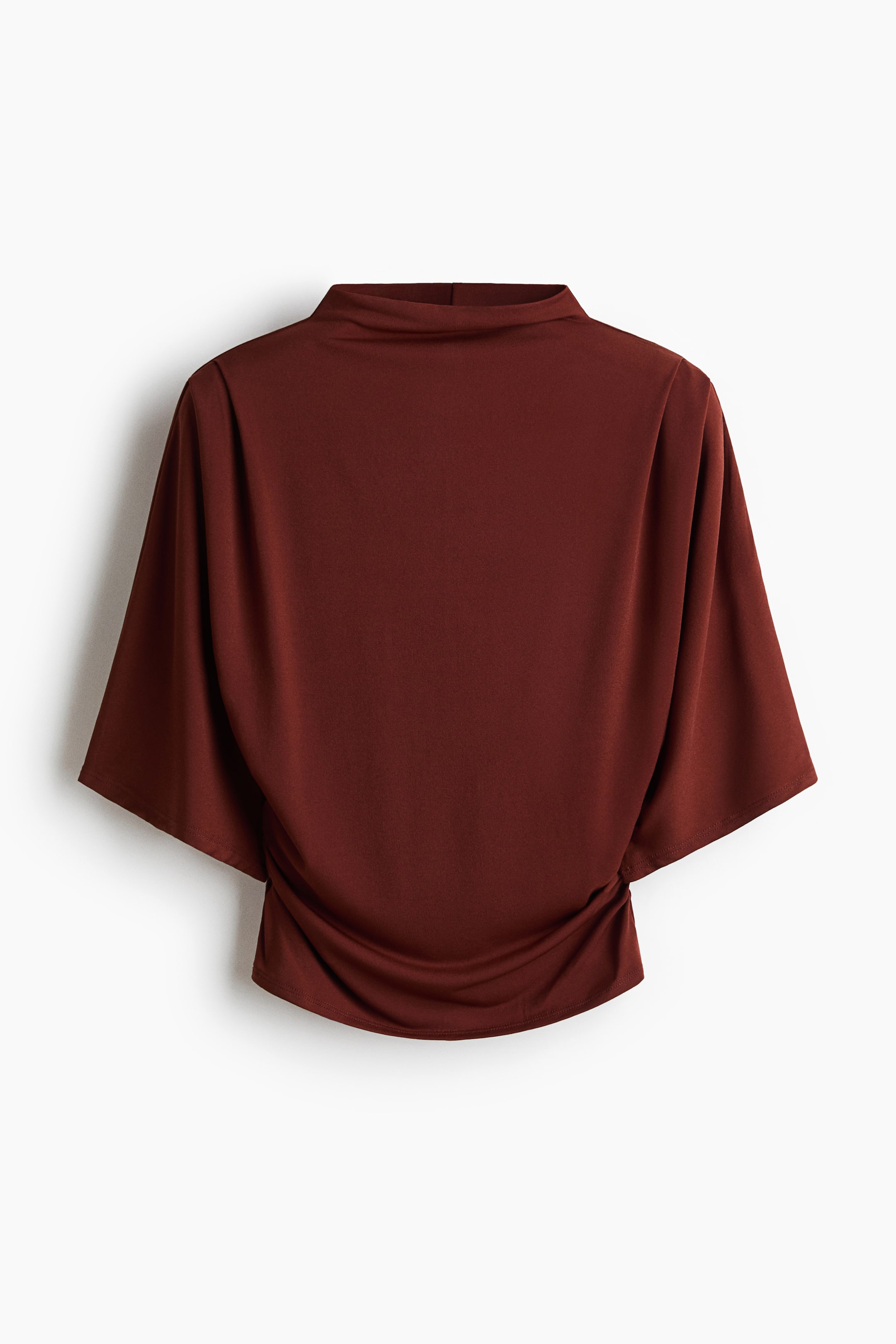 View larger image: A deep reddish-brown top is presenting its back view, featuring a stand-up collar and short, wide dolman sleeves. The bottom hem is showing ruched detailing on both sides.