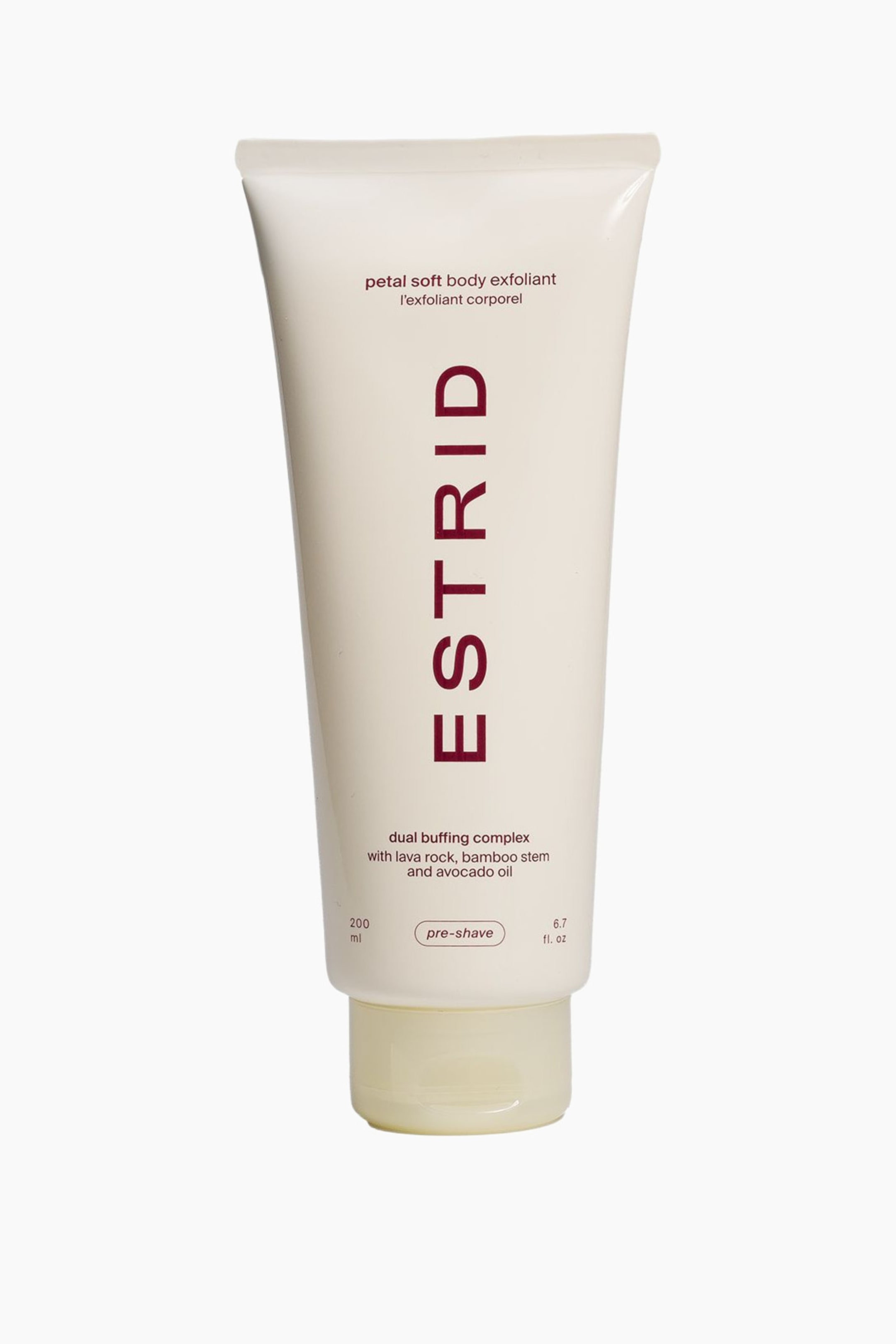 Visa större bild: En krämfärgad klämtub av Estrid petal soft body exfoliant står upprätt, vänd framåt. Tuben har "ESTRID" tryckt vertikalt i en mörk rödbrun färg, tillsammans med beskrivningar av "petal soft body exfoliant", ett "dual buffing complex" och "pre-shave". En genomskinlig, ljusare krämfärgad kork är synlig längst ner.