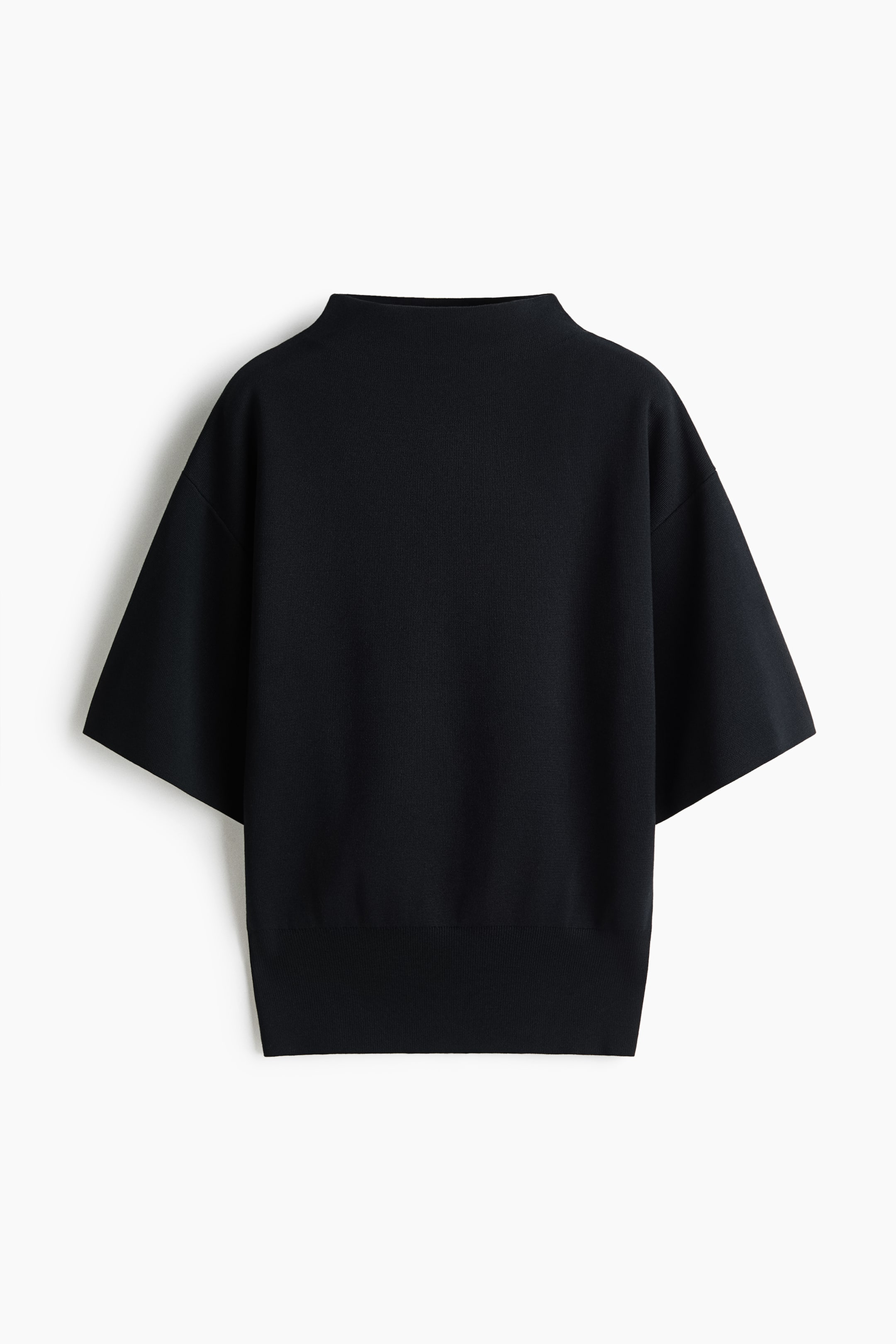View larger image: A black knit top is shown from the front, featuring a mock neck, wide short sleeves with dropped shoulders, and a ribbed hem.