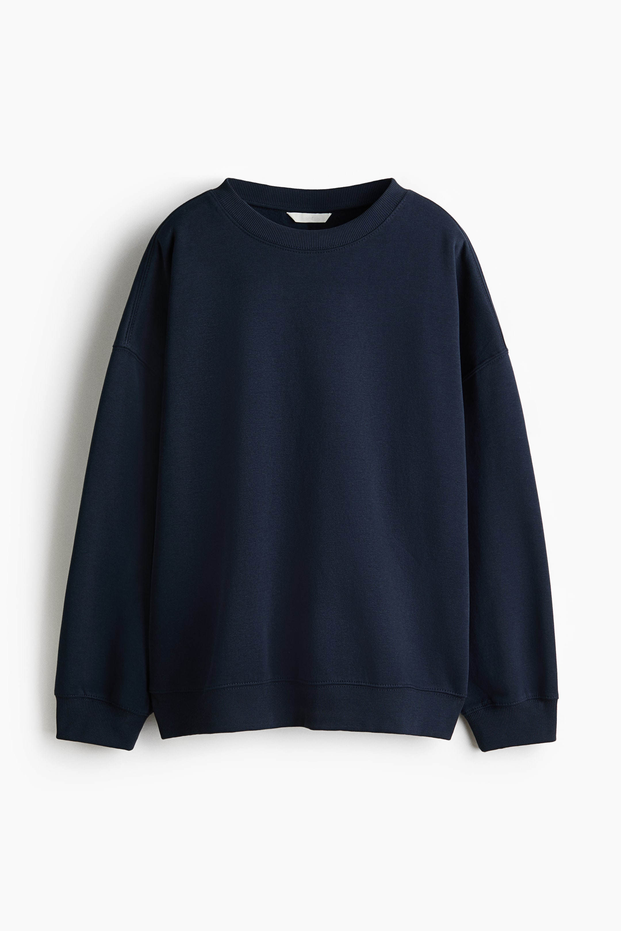 View larger image: An oversized, dark blue sweatshirt is shown from the front. It features a round, rib-trimmed neckline, dropped shoulders, and long sleeves with ribbed cuffs and a ribbed hem.