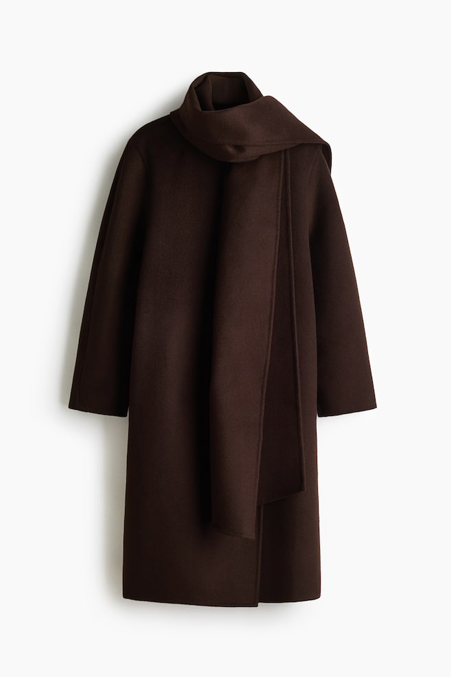 A dark brown coat is featuring long sleeves and an integrated scarf that is draping around the neck and down the open front. - 1