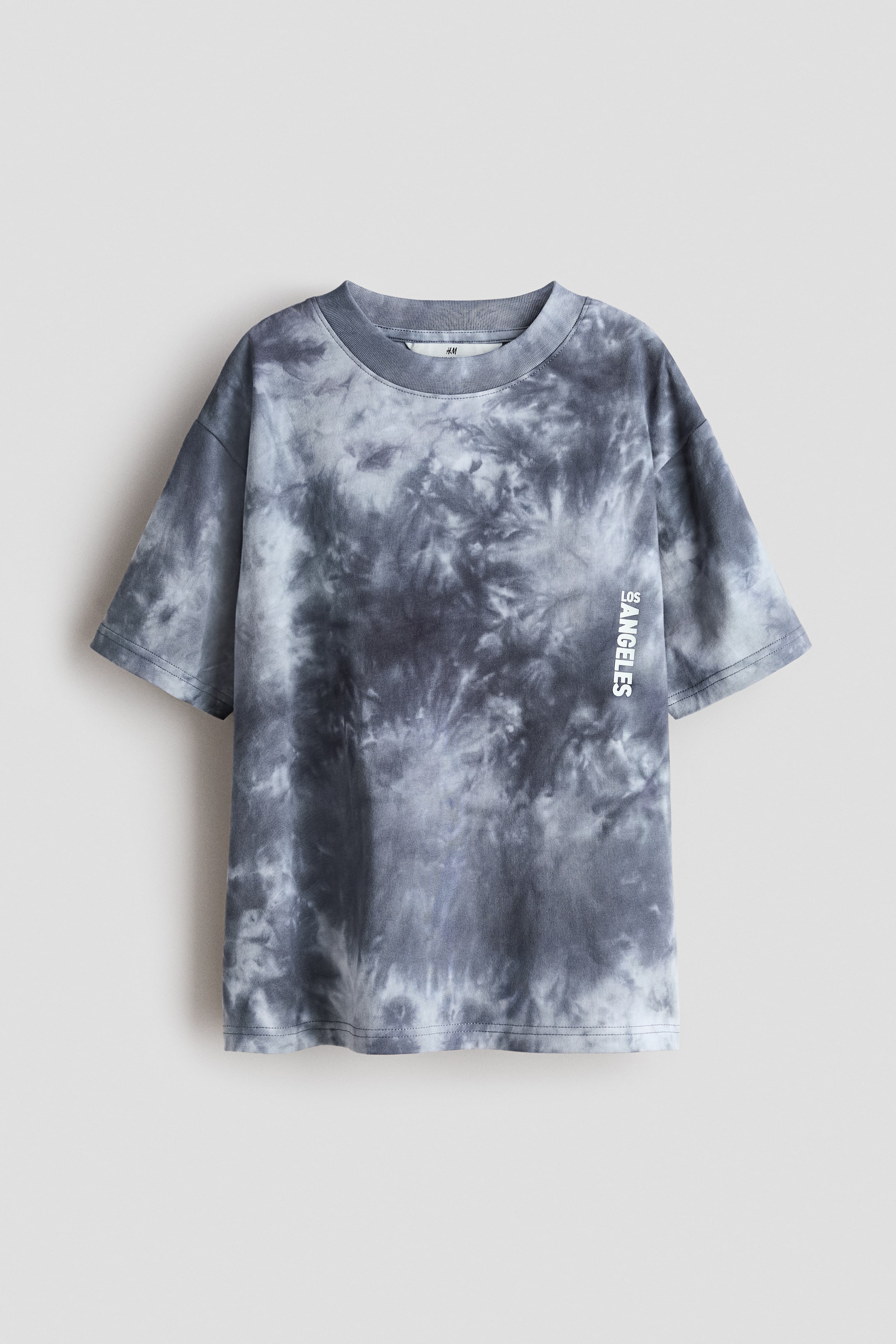 View larger image: Presenting a loose-fit t-shirt crafted from printed cotton jersey, prominently displayed in the FRONT view. It showcases a striking grey and white tie-dye pattern. The design features a ribbed trim around the neckline, with dropped shoulders, and the text "LOS ANGELES" printed vertically on the right side of the chest.