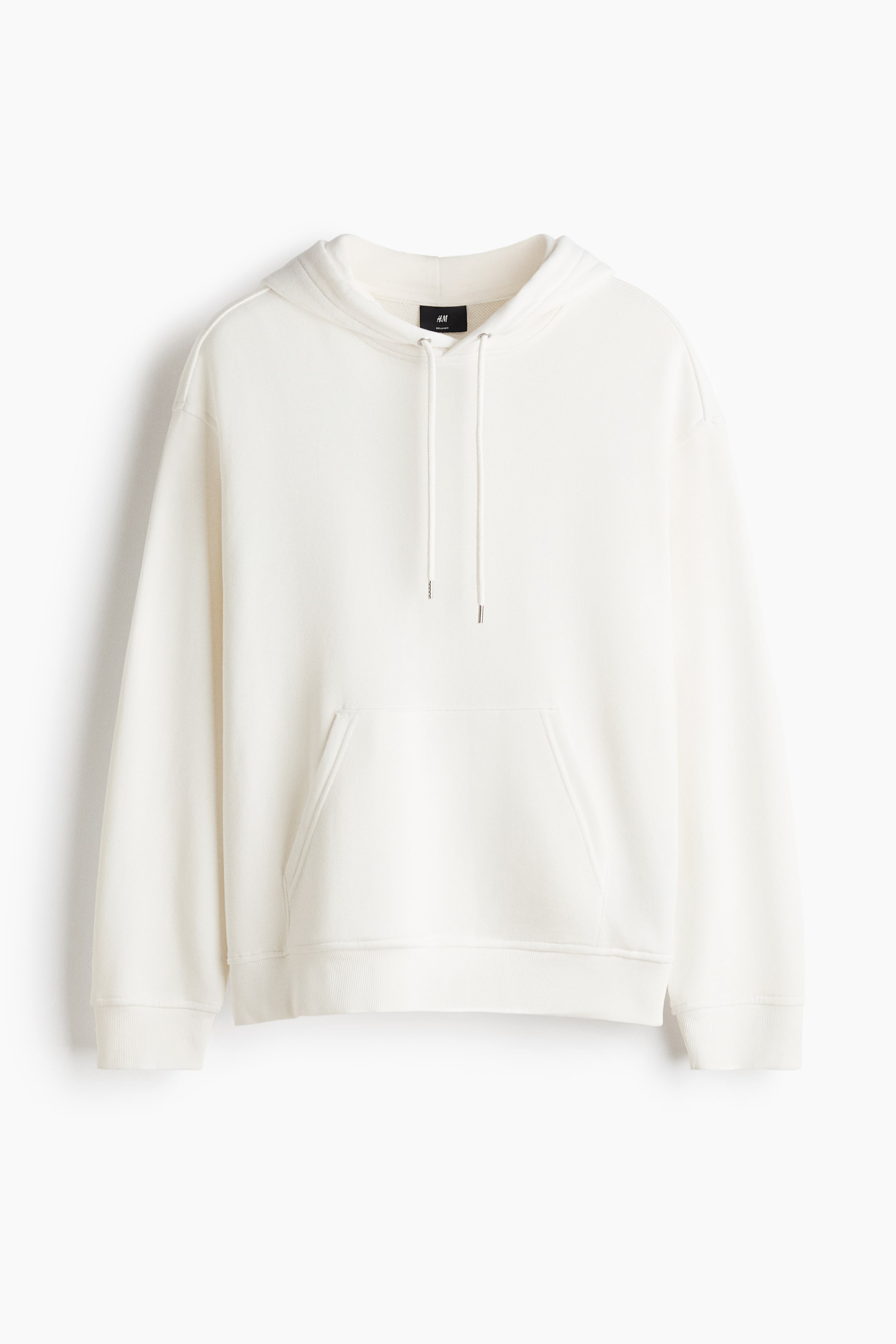 View larger image: This cream-coloured hoodie is shown from the front, featuring a relaxed fit with a drawstring hood and dropped shoulders. It is designed with a roomy front kangaroo pocket and ribbed detailing at the cuffs and hem.
