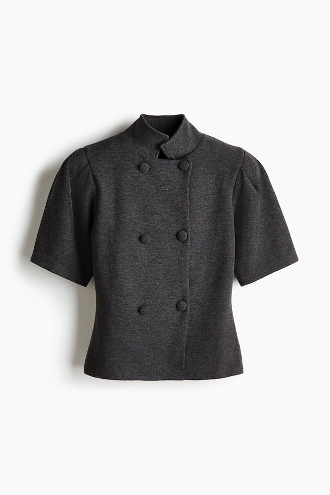 A dark grey knit top is facing forward, featuring a double-breasted front with six fabric-covered buttons and a high stand collar. It is showcasing short, structured puff sleeves with gathered shoulders and a slightly tapered waist. - 1