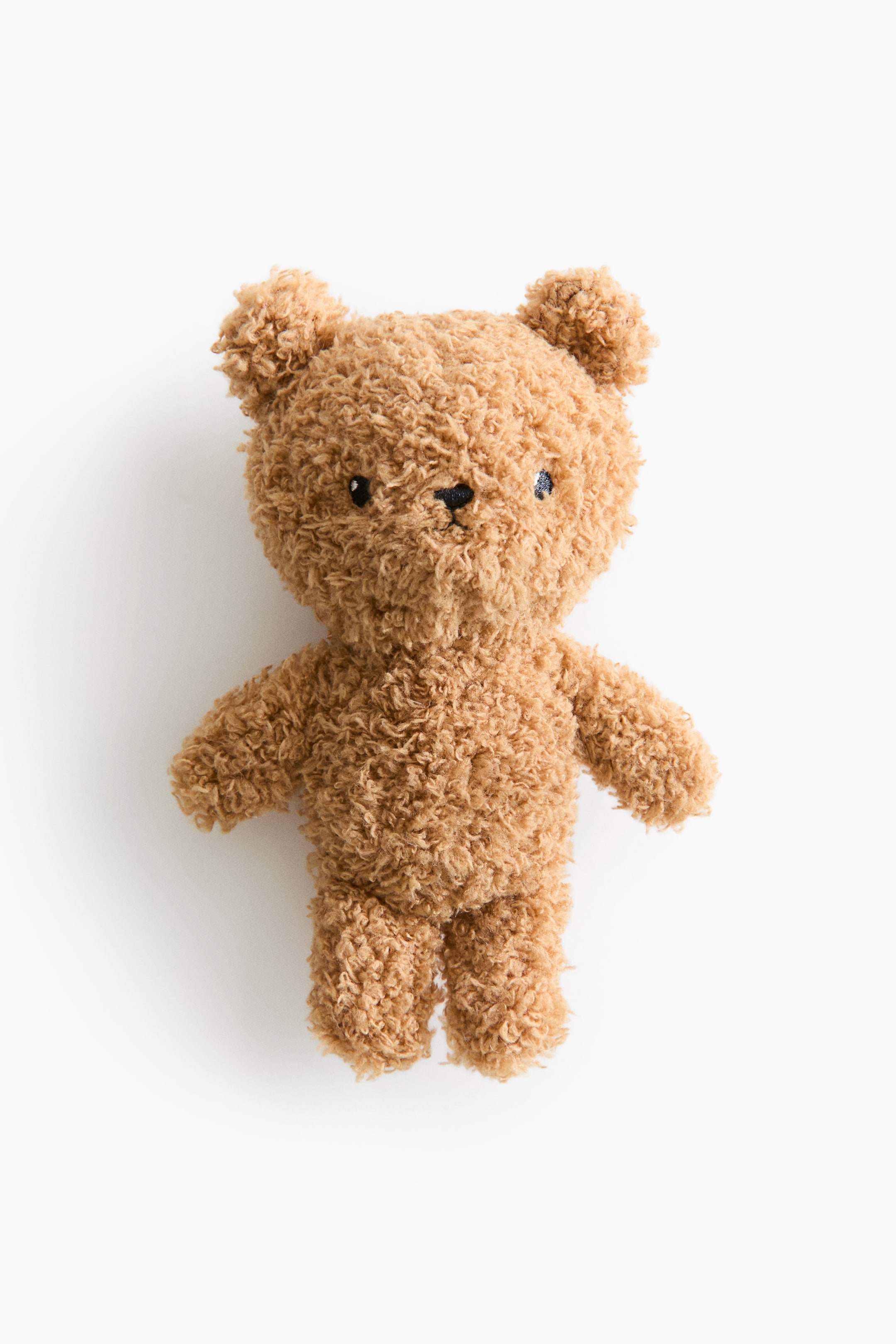View larger image: A plush baby rattle, shaped like a light brown teddy bear, is facing forward. It features a soft pile texture and is detailed with embroidered eyes and nose.
