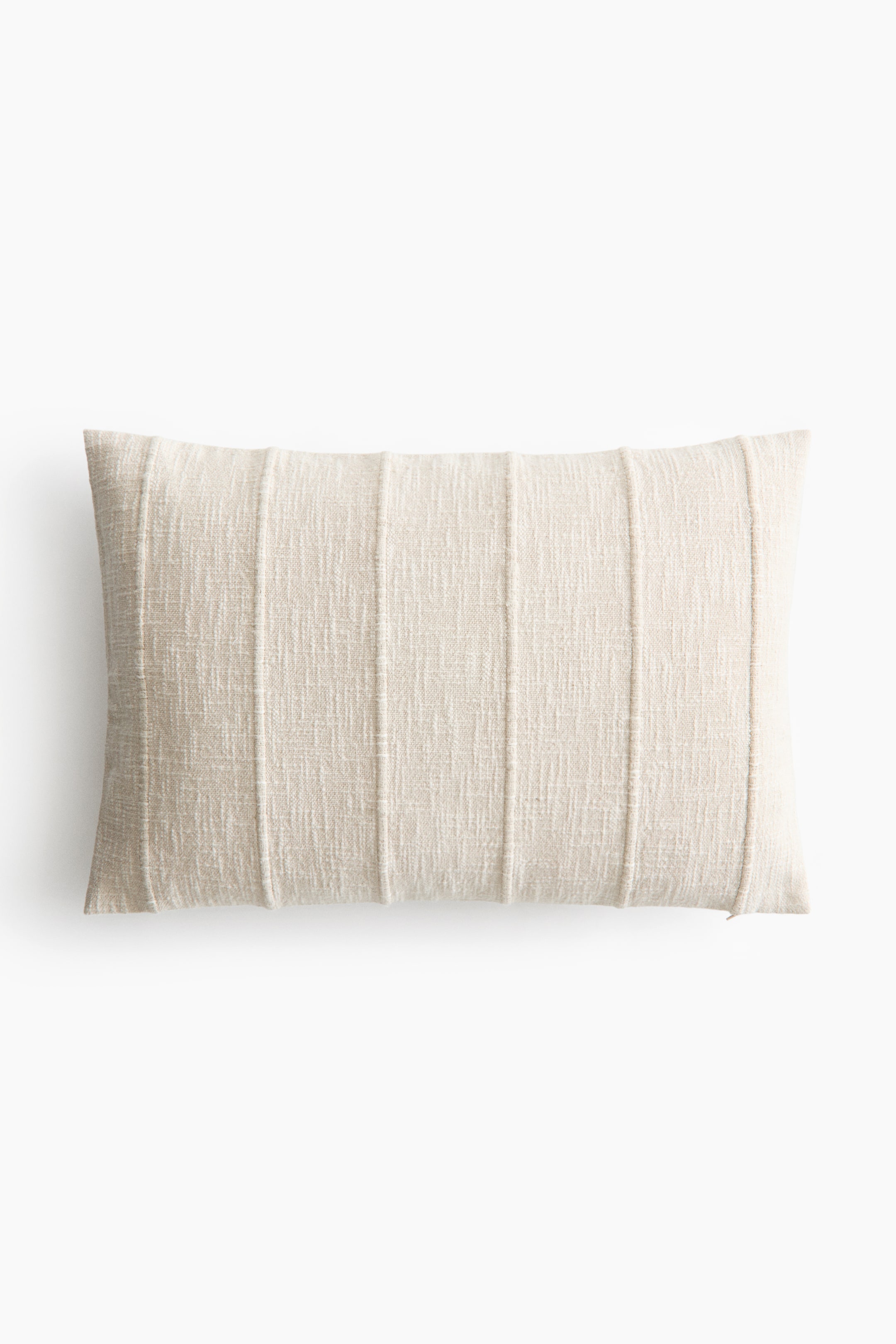 View larger image: A rectangular lumbar pillow showcases a textured, light beige woven fabric. It features several vertical stitched pleats running across its front surface.