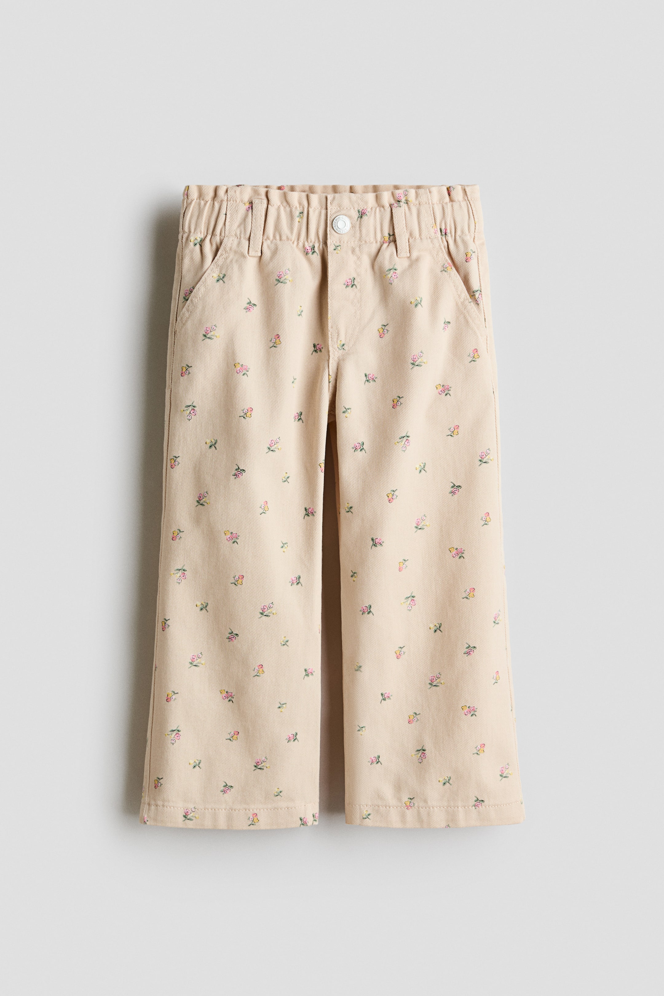 Visualizza immagine più grande: Jeans Wide Leg con vita a sacchetto - Beige chiaro/fiori - BAMBINO | H&M IT 1