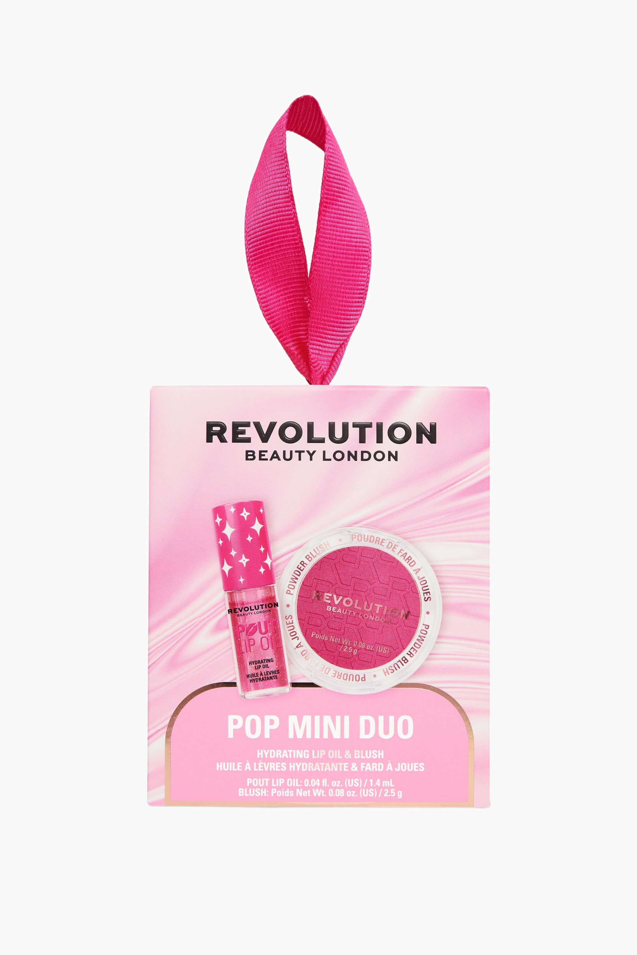 Visa större bild: Revolution Pop Mini Duo sminkpresentsetet innehåller ett mini pink lip oil och ett mini pink powder blush i en ljusrosa dekorativ förpackning. Förpackningen har en klarrosa upphängningsögla i form av ett band upptill, och den genomskinliga tuben med lip oil samt den runda puderdosan med blush är placerade på framsidan.