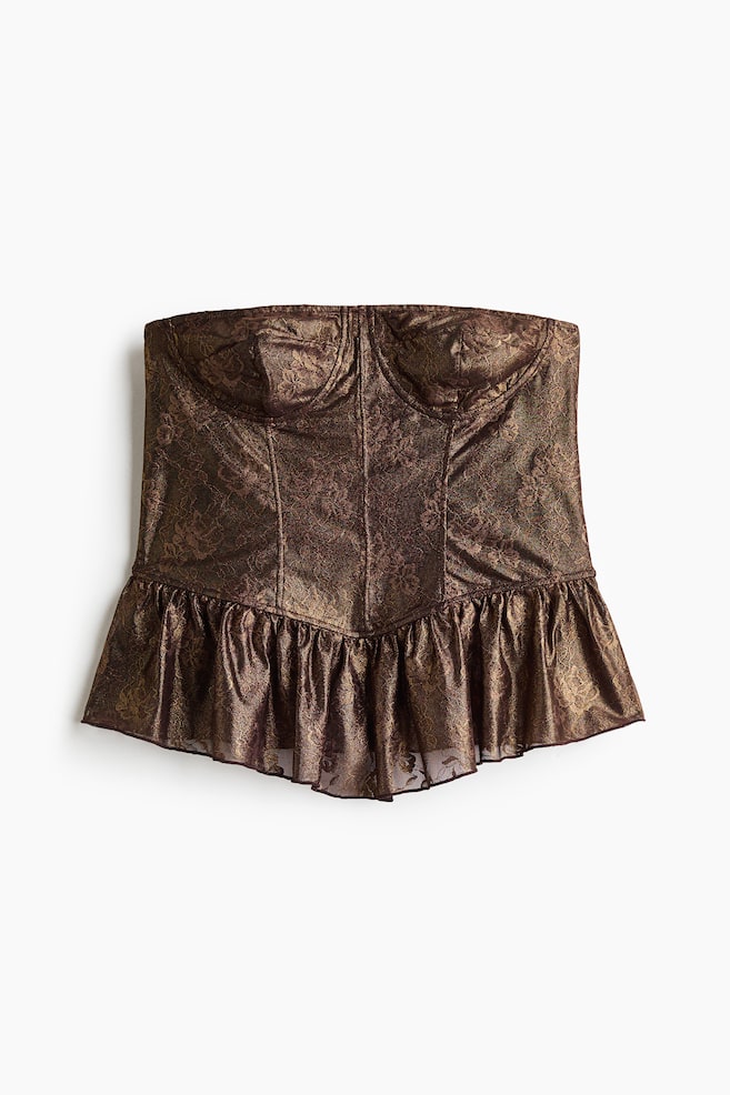 A fitted bandeau bustier top in dark brown and gold-toned metallic lace is shown from the front, featuring a sweetheart neckline, shaped cups, and vertical boning seams. The bodice transitions into a flared peplum hem with an angled, gathered seam. - 1