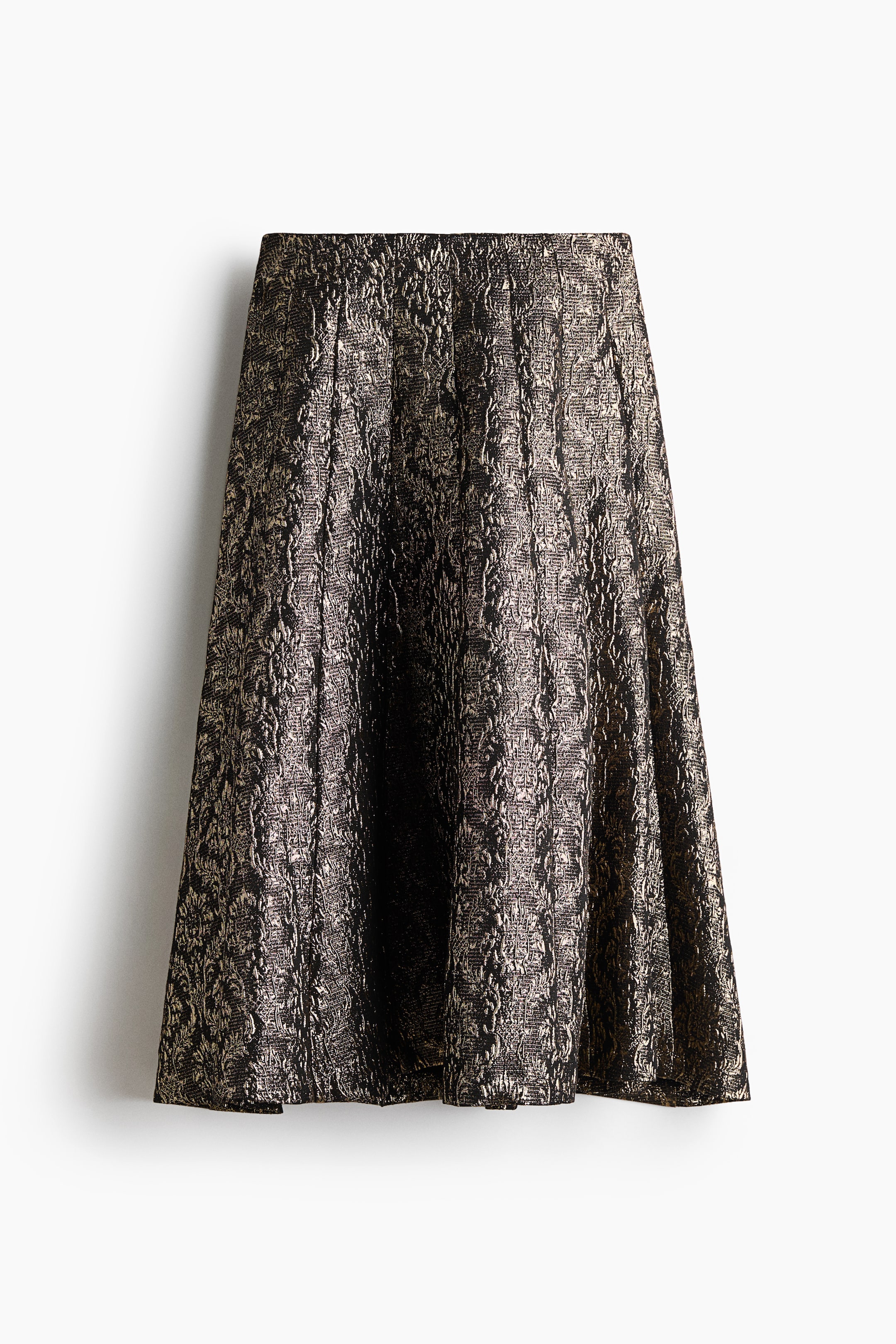 View larger image: An A-line skirt featuring a metallic gold and black textured jacquard pattern is hanging from the front, showcasing a structured high waist and a flared, voluminous silhouette with deep pleats.
