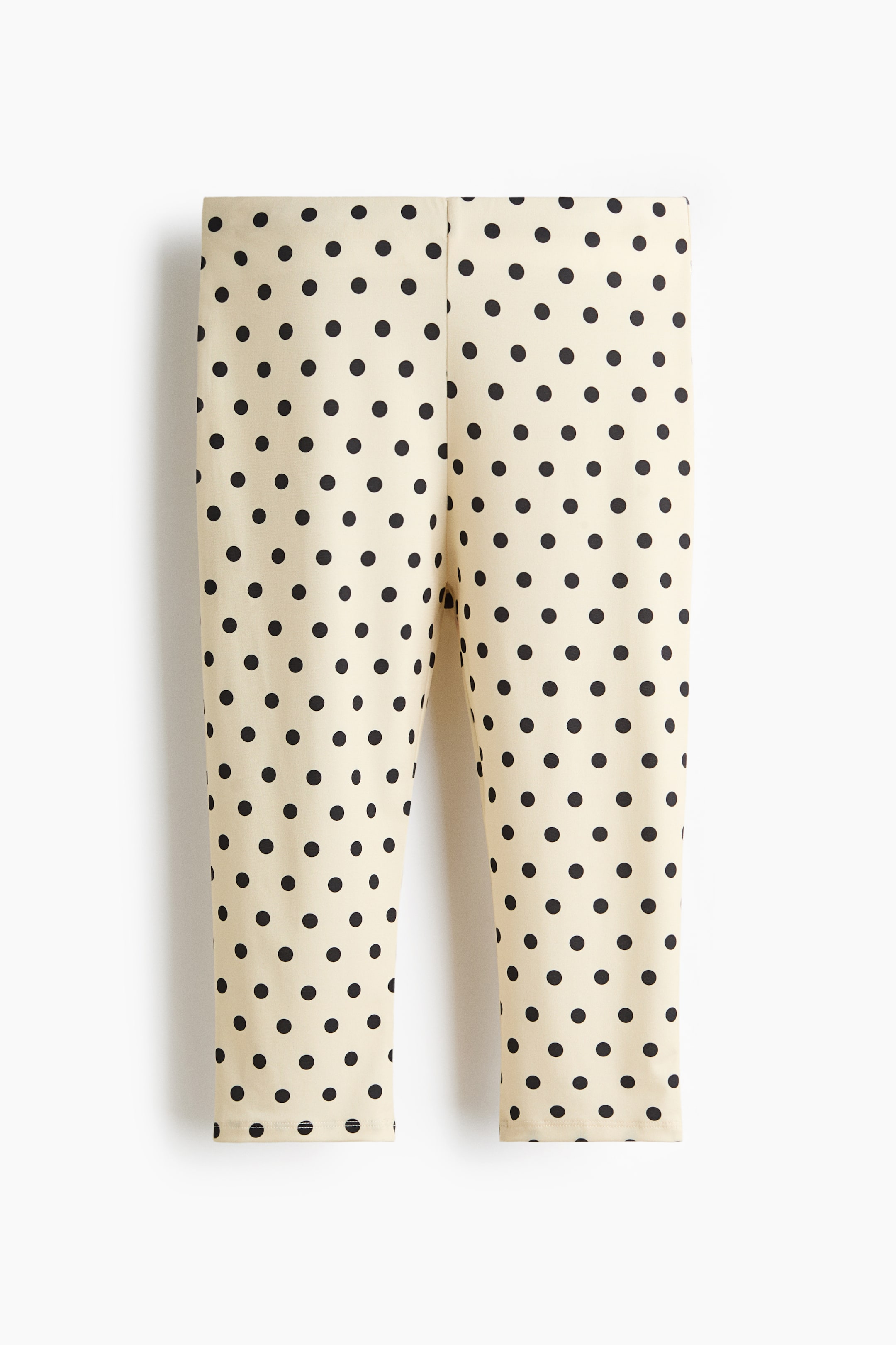 Se større billede: Leggings præsenteres forfra, med en cremefarvet base og et mønster af jævnt fordelte sorte polkaprikker over det hele.
