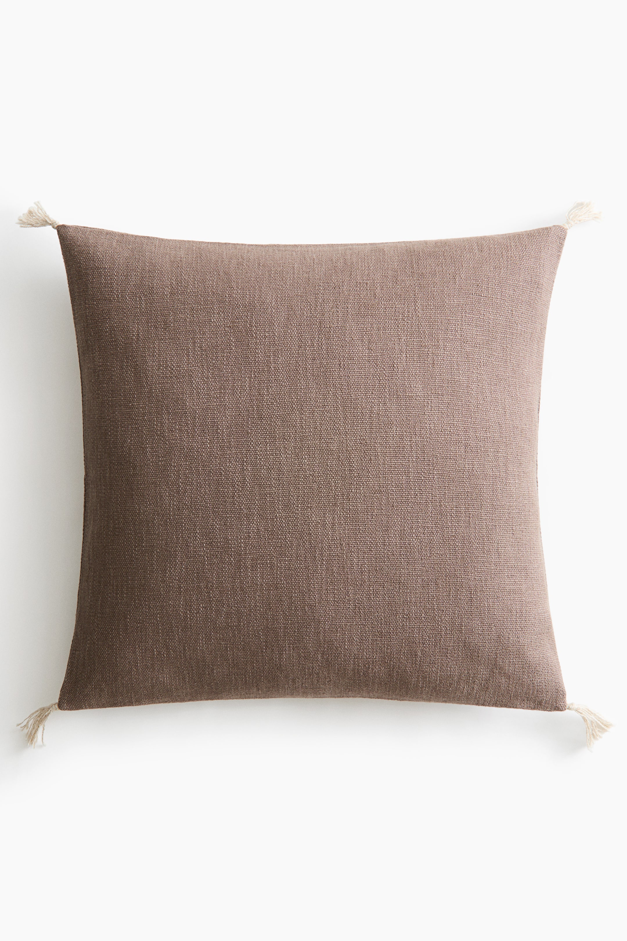 View larger image: A square throw pillow in a textured, woven brown fabric is shown from the front, featuring small off-white tassels at each of its four corners.