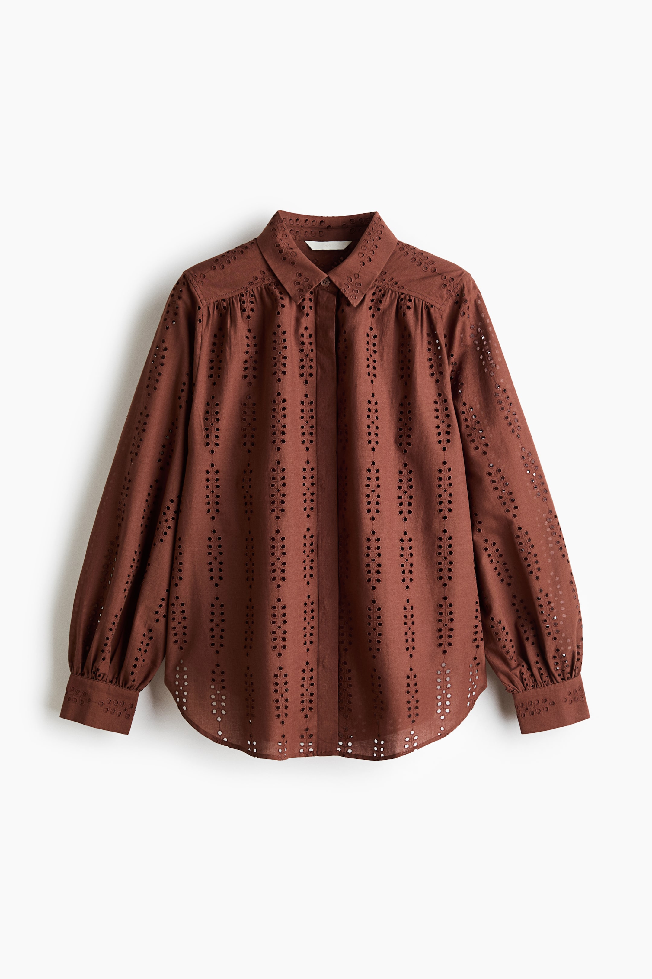 View larger image: A brown eyelet shirt is displayed facing front, featuring a classic pointed collar and a button-down front. It showcases long, puffed sleeves with gathered shoulders and buttoned cuffs, and an intricate eyelet cutwork pattern details the entire garment, finishing with a rounded hem.
