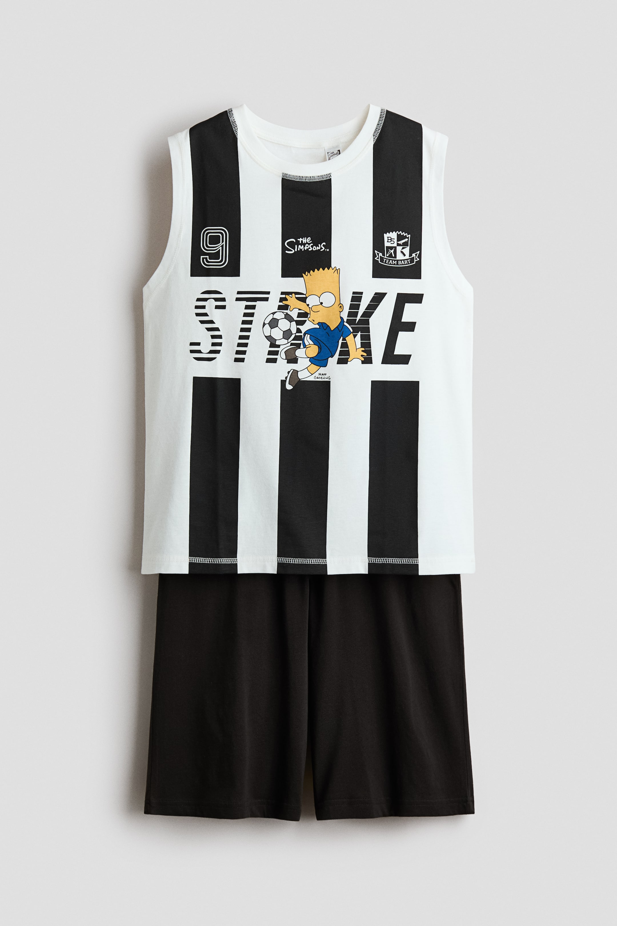 View larger image: Short pyjamas are shown from the front, featuring a sleeveless top with a round, rib-trimmed neckline and black and white vertical stripes, displaying a graphic print of Bart Simpson kicking a football, 'STRIKE' text, 'The Simpsons' logo, the number '9', and a 'TEAM BART' crest. The coordinating shorts are solid black with an elasticated waist.