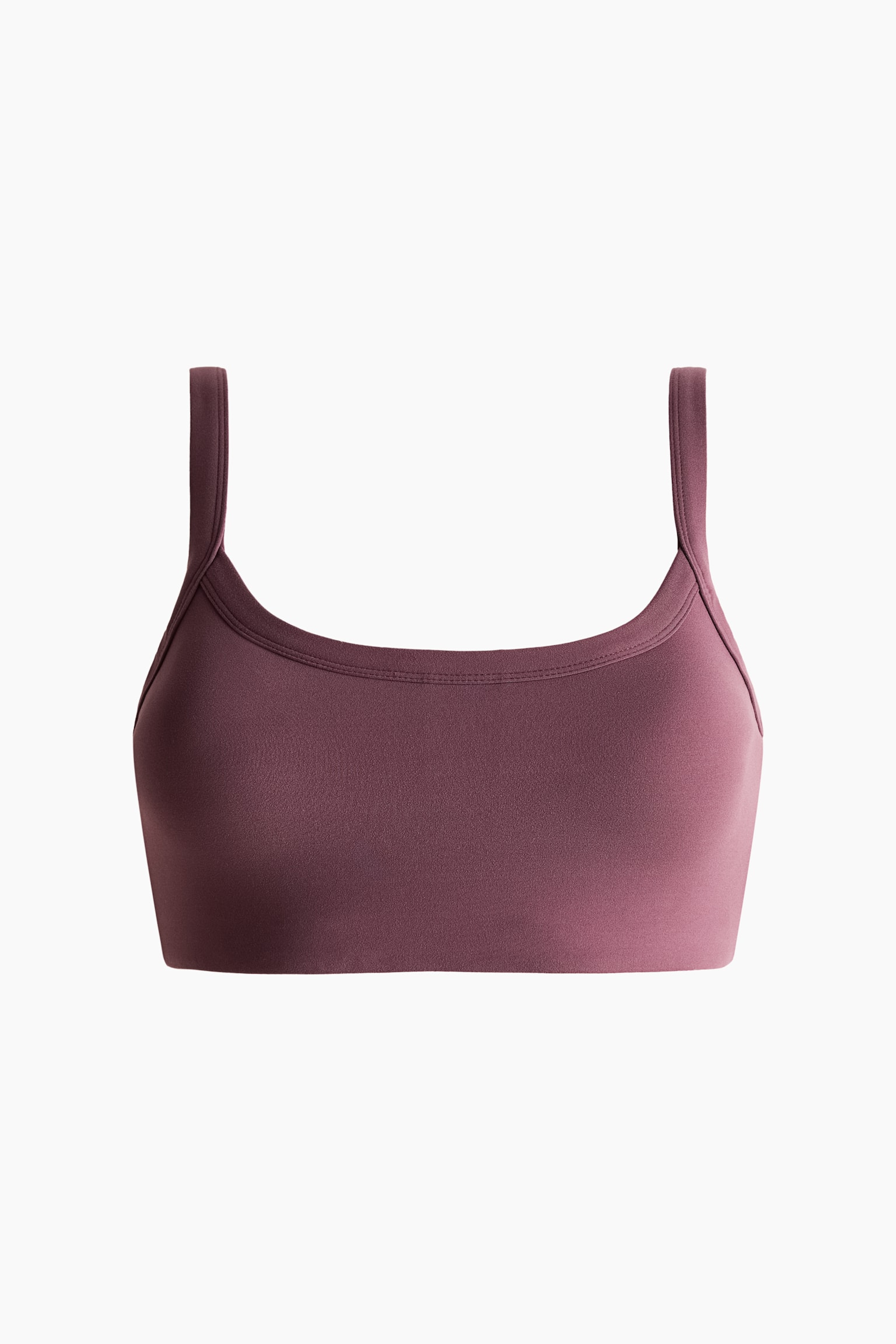 Un soutien-gorge de sport mauve avec un décolleté en U, de larges bretelles et des coutures discrètes autour du décolleté. - 1