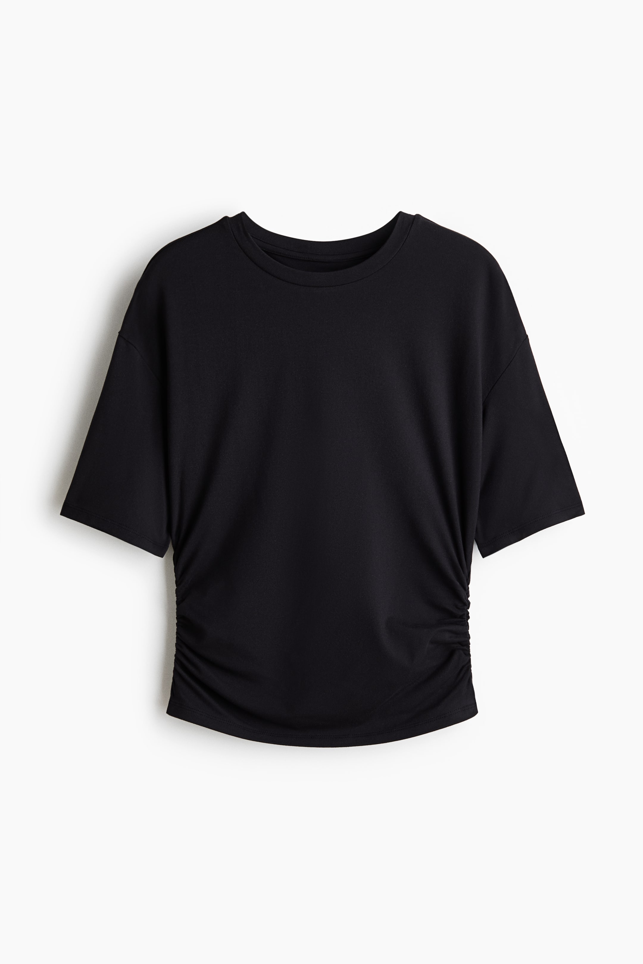View larger image: A black T-shirt shown from the front, featuring a crew neck and dropped shoulders. Ruching gathers the soft jersey fabric on both sides, creating a fitted silhouette and a draped effect.