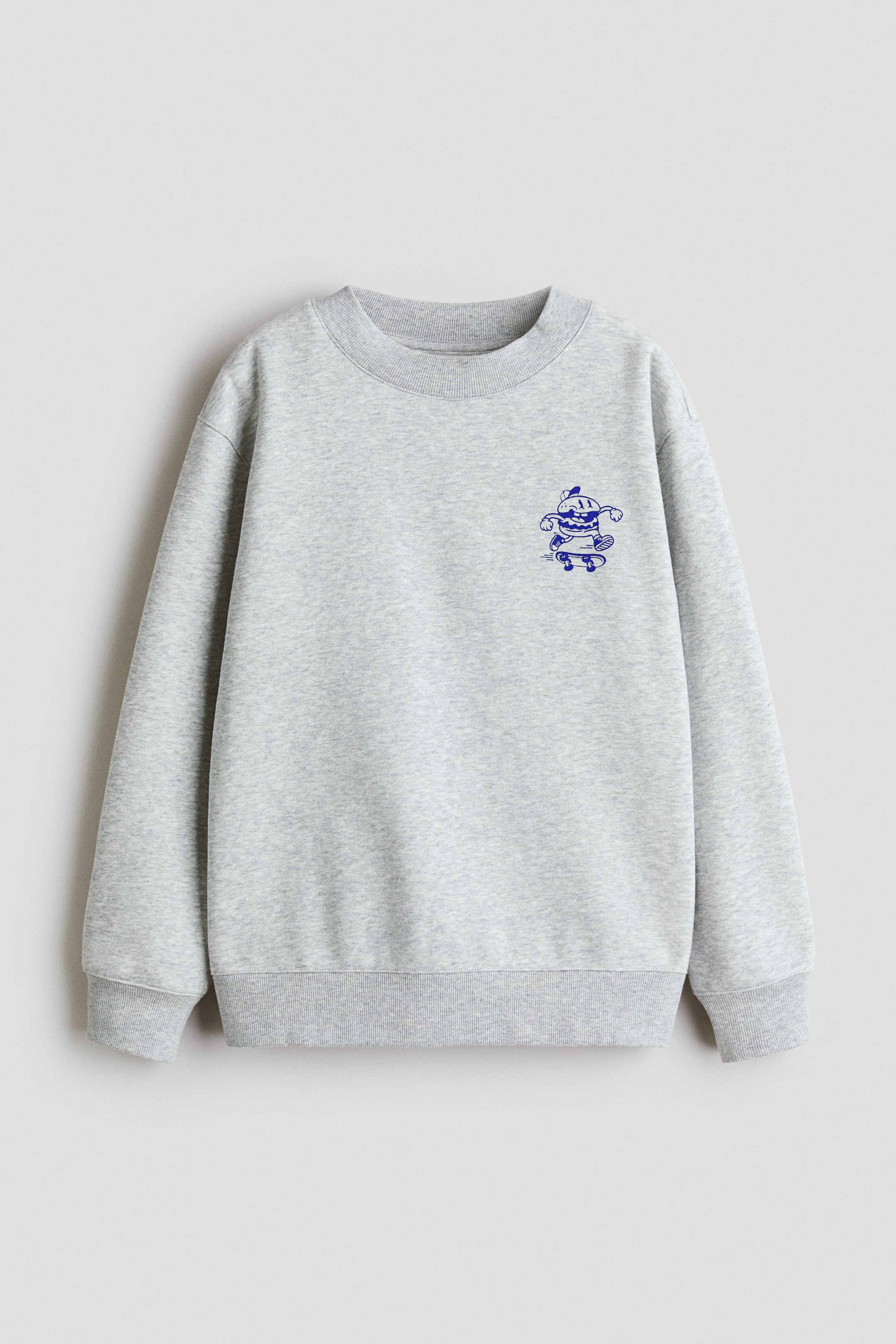 View larger image: A grey sweatshirt showcases its front, adorned with a blue graphic of a character on a skateboard positioned on the left chest. It is crafted with a round, rib-trimmed neckline, dropped shoulders, long sleeves, and ribbed cuffs and hem.