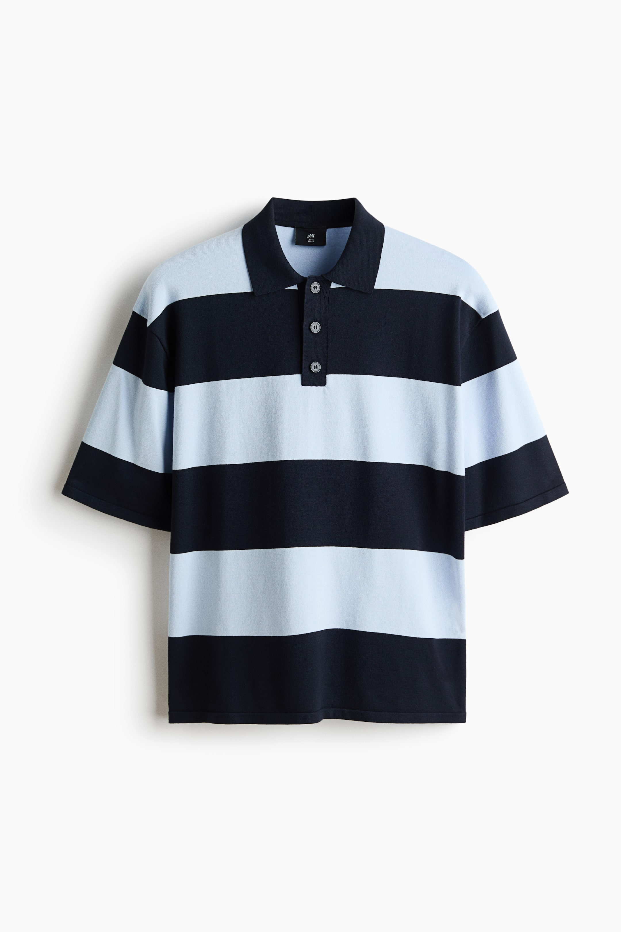 View larger image: This polo shirt showcases broad horizontal stripes in a soothing light blue and deep navy. It is crafted with a navy polo collar, a three-button placket, and short sleeves.