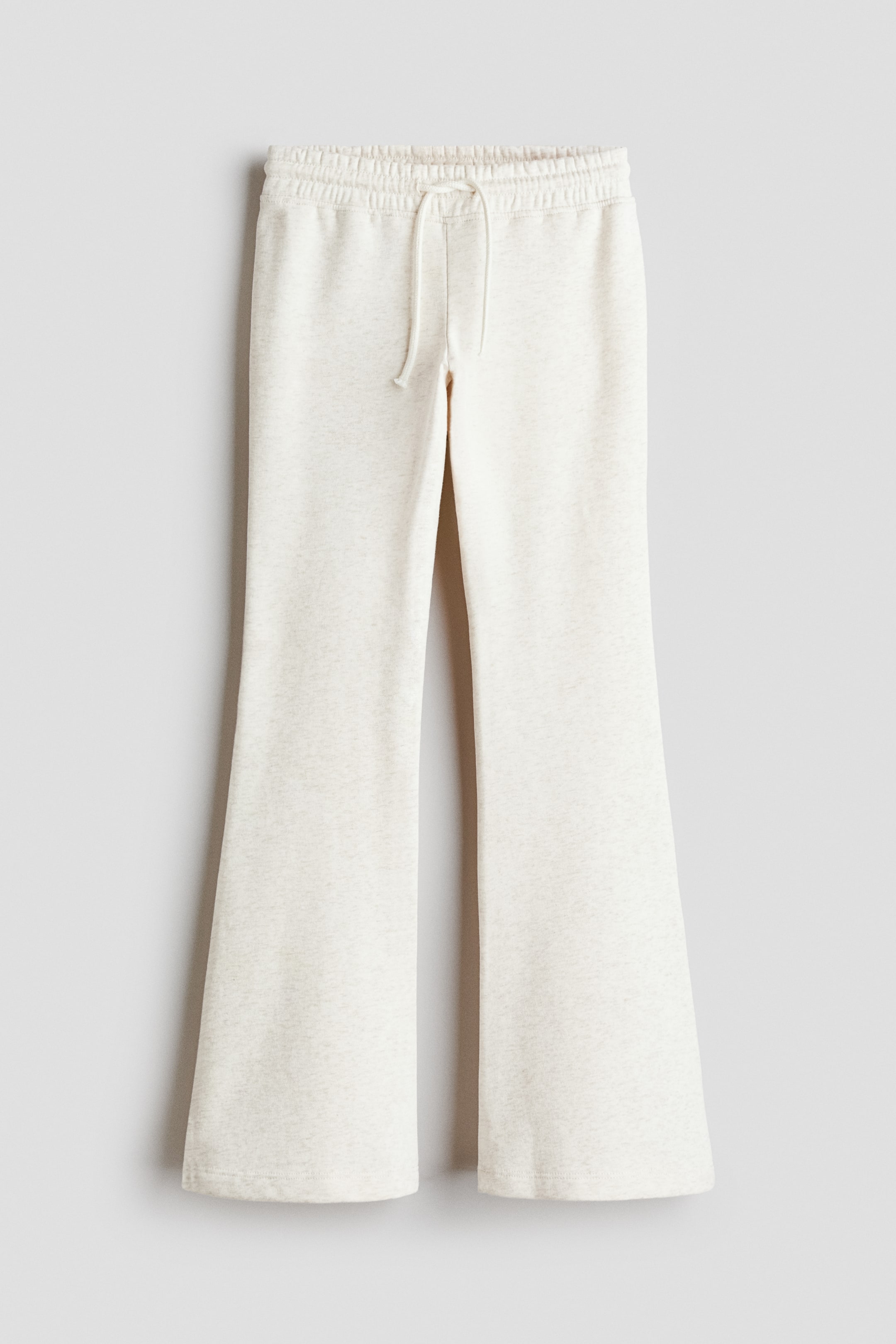 View larger image: Joggers in a light heathered off-white fabric feature an elasticated drawstring waist and flared legs.