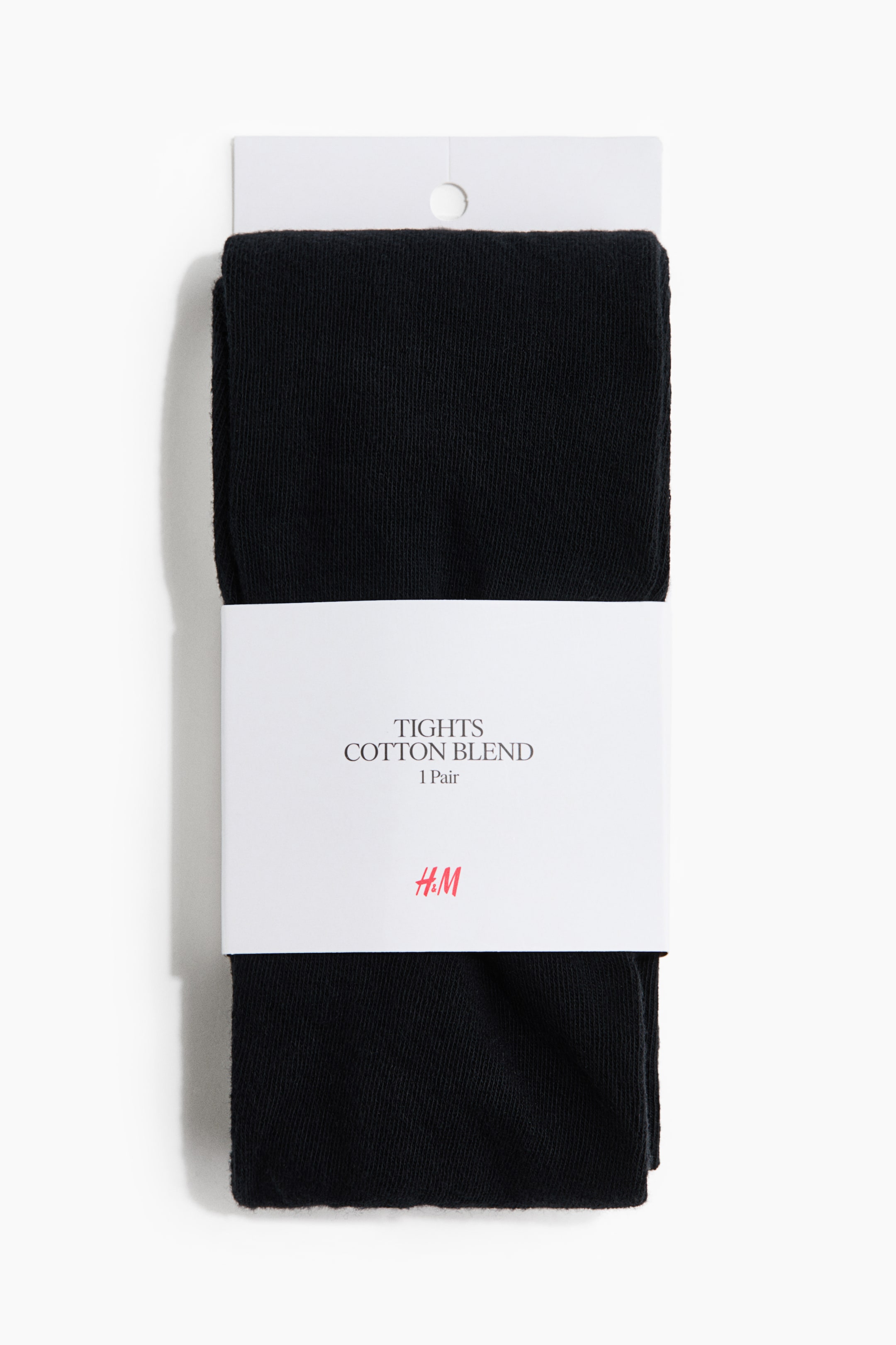 View larger image: Black tights are presented folded and front-facing, secured by a white cardboard band. The band displays the text "TIGHTS COTTON BLEND 1 Pair" and an H&M logo, while a white cardboard header with a hanging hole is visible at the top.